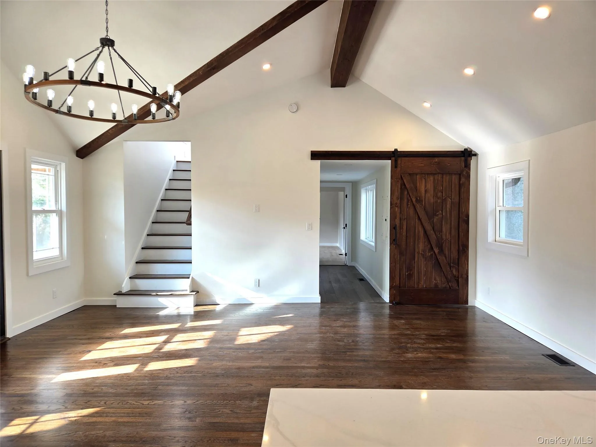 Another View Of The Great Room From The Custom Chef's Kitchen. The Great Room Offers Stunning Soaring Beamed Ceilings, Hardwood Floors, Recessed Lighting, Chandelier, All Beautiful Details & A Barn Door To The Primary Bedroom. Another View Of The Great Room From The Custom Chef's Kitchen. The Great Room Offers Stunning Soaring Beamed Ceilings, Hardwood Floors, Recessed Lighting, Chandelier, All Beautiful Details & A Barn Door To The Primary Bedroom.