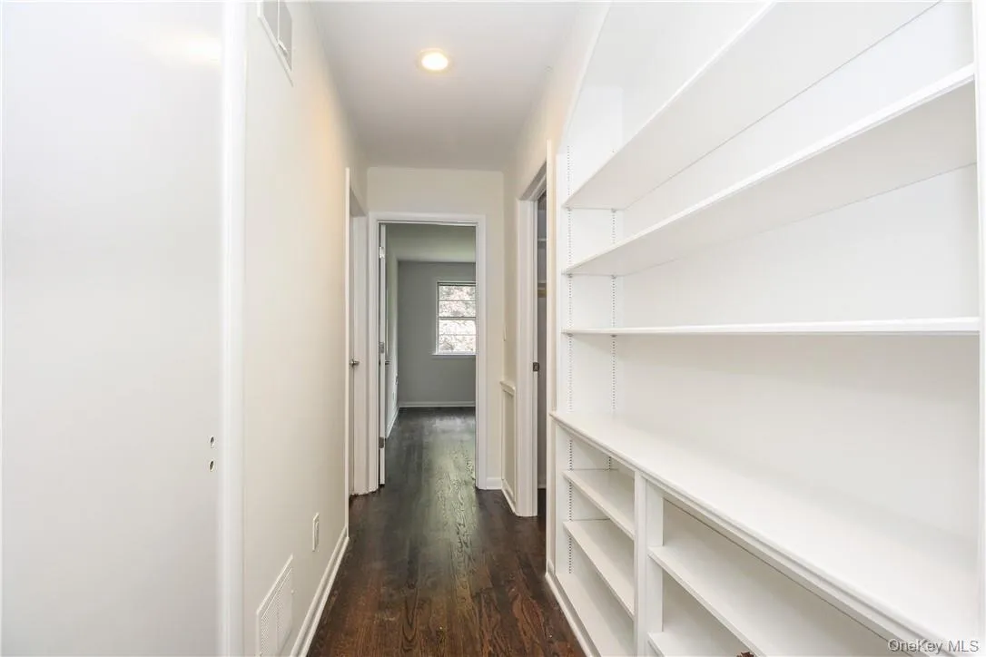 Hallway has 2 walkin closets and built-in shelves, two bedrooms at the far end and full bath Hallway has 2 walkin closets and built-in shelves, two bedrooms at the far end and full bath