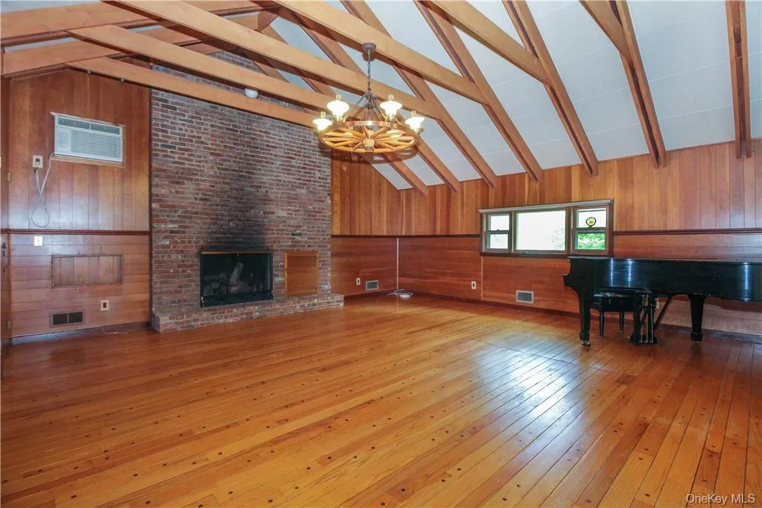 Den with brick fireplace, vaulted beamed cieling, peg and dart hardwood floors, Steinway baby grand Den with brick fireplace, vaulted beamed cieling, peg and dart hardwood floors, Steinway baby grand
