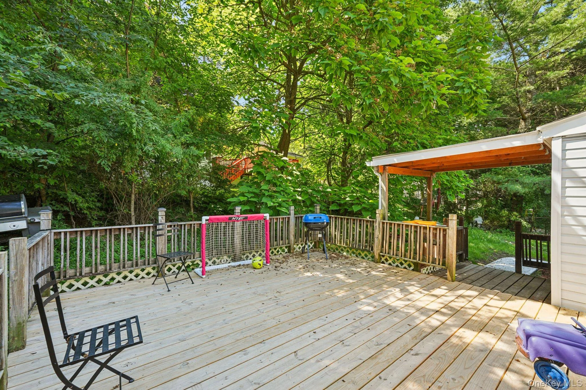 Wooden deck with view of scattered trees Wooden deck with view of scattered trees