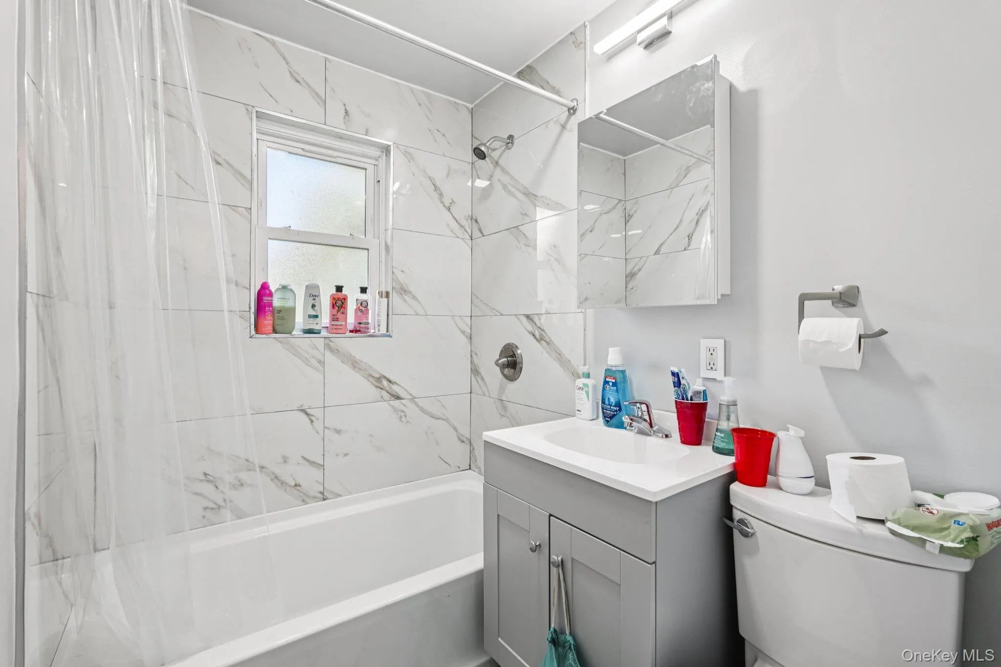 Bathroom featuring vanity and shower / tub combo Bathroom featuring vanity and shower / tub combo