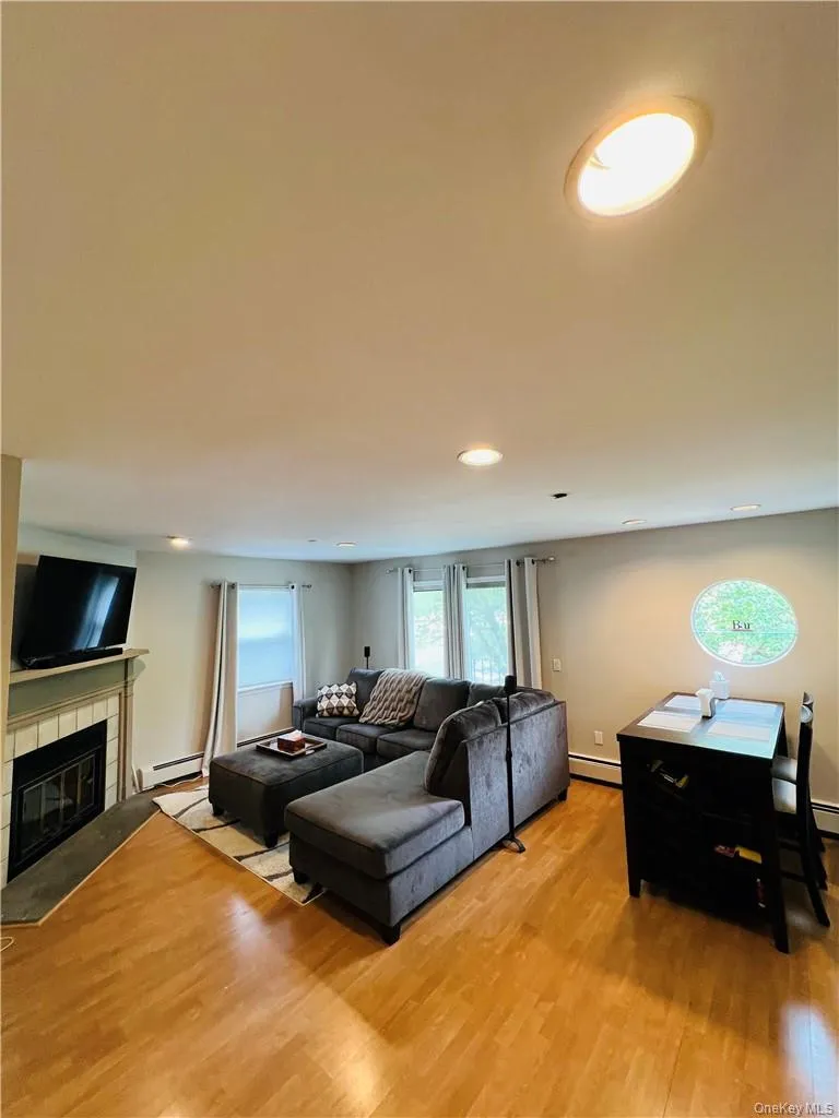 Living room with fireplace, SGD and lhardwood flooring Living room with fireplace, SGD and lhardwood flooring