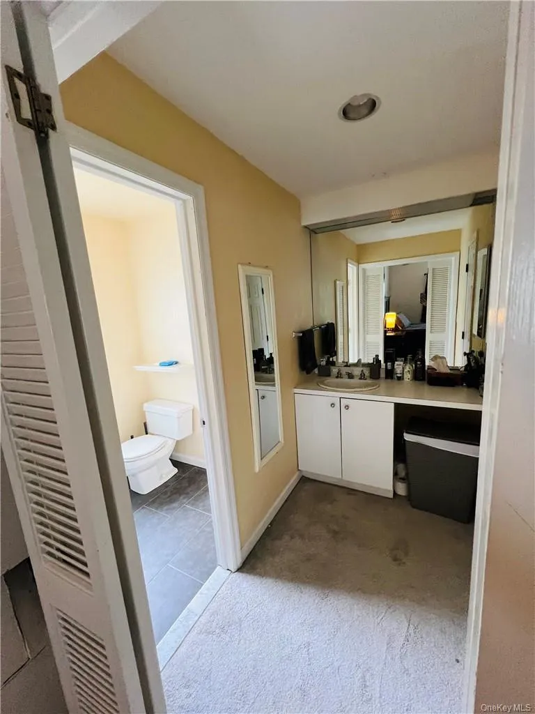 Bathroom with tile patterned flooring, toilet, and vanity Bathroom with tile patterned flooring, toilet, and vanity