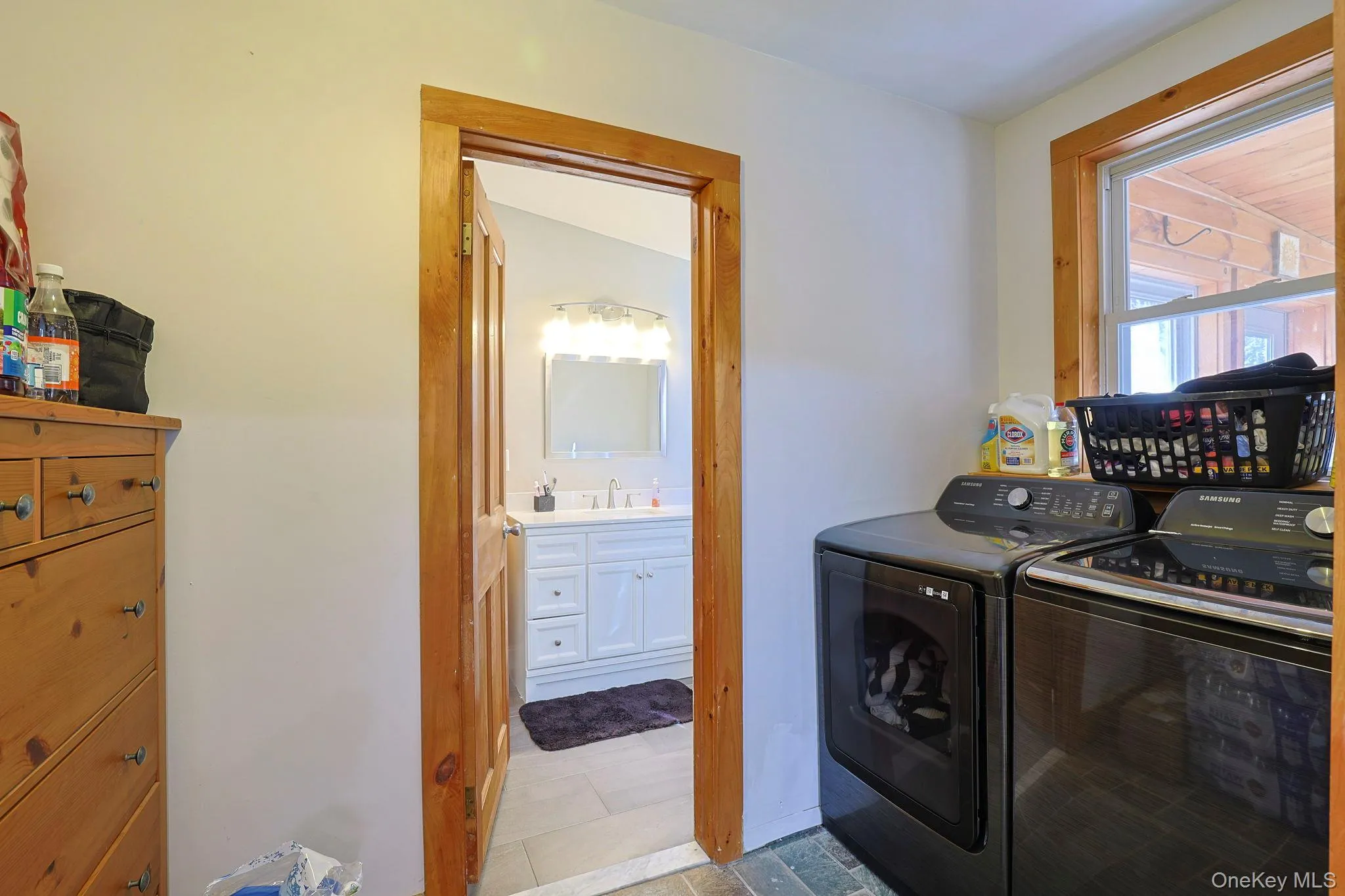 Clothes washing area with washing machine and clothes dryer, a sink, and laundry area Clothes washing area with washing machine and clothes dryer, a sink, and laundry area