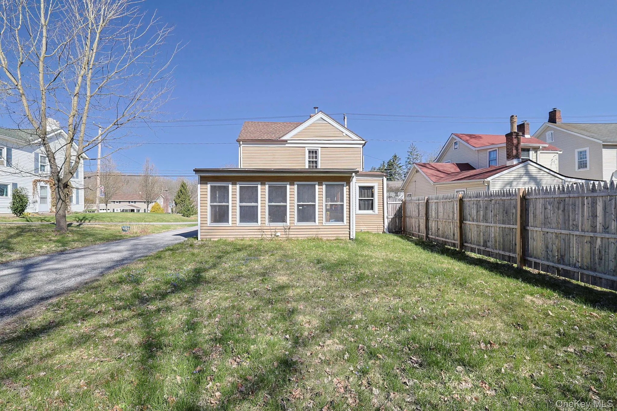 Rear view of property featuring fence and a yard Rear view of property featuring fence and a yard