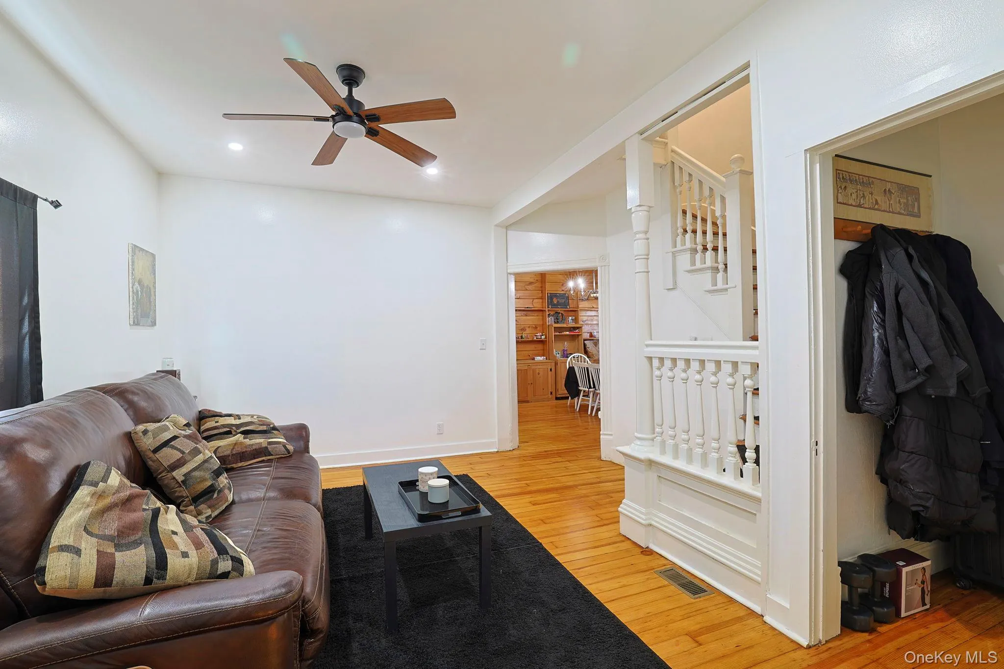 Living room featuring light wood-type flooring, a ceiling fan, visible vents, and recessed lighting Living room featuring light wood-type flooring, a ceiling fan, visible vents, and recessed lighting