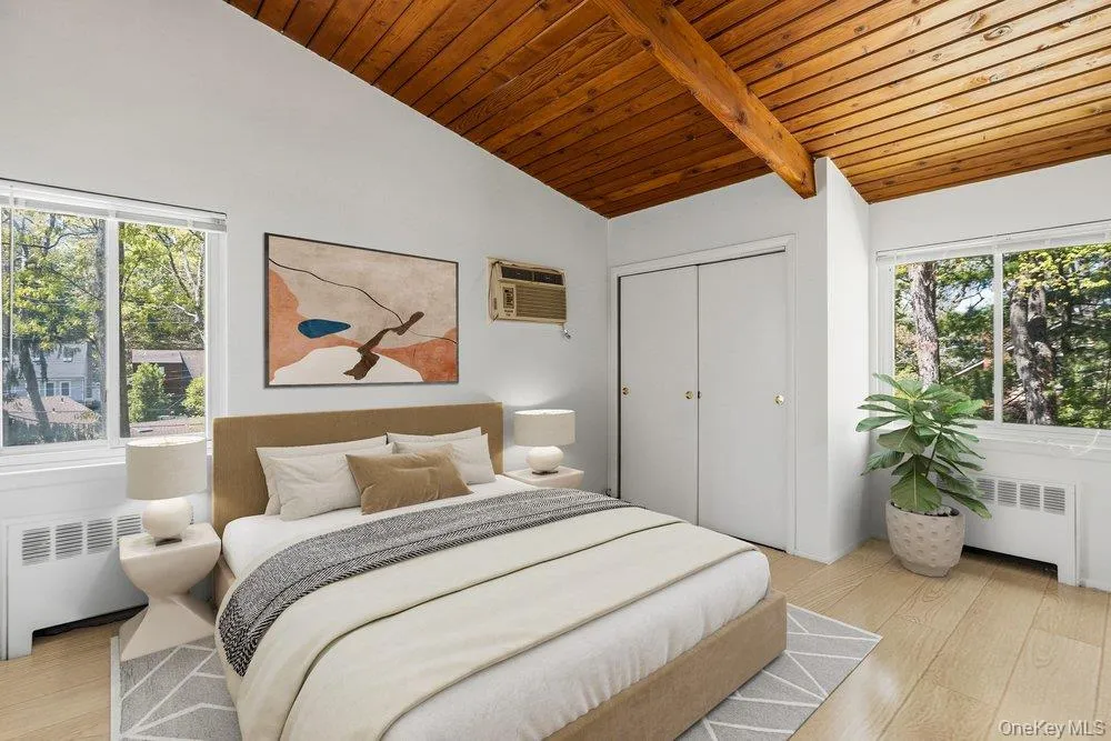 Vaulted wood-plank ceiling with exposed beam and dual windows Vaulted wood-plank ceiling with exposed beam and dual windows