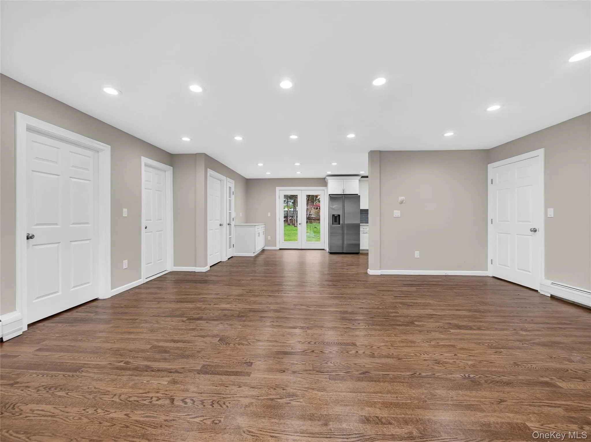 Unfurnished living room with recessed lighting, and dark wood finished floors Unfurnished living room with recessed lighting, and dark wood finished floors
