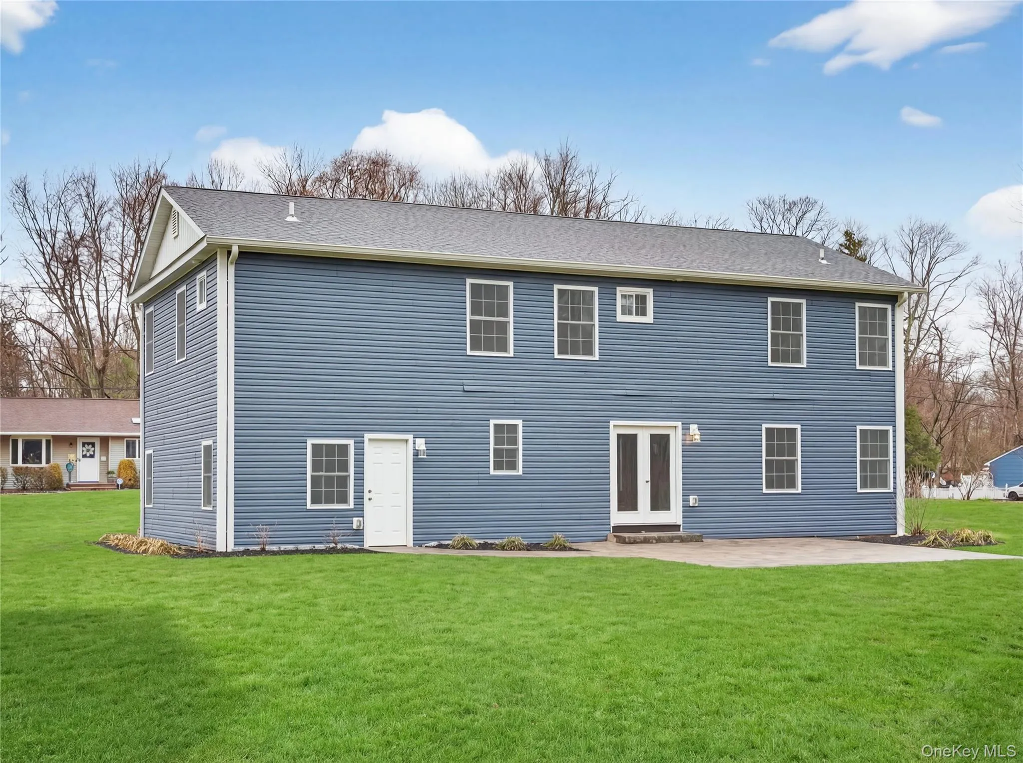Back of property featuring a yard, a patio area, and french doors Back of property featuring a yard, a patio area, and french doors
