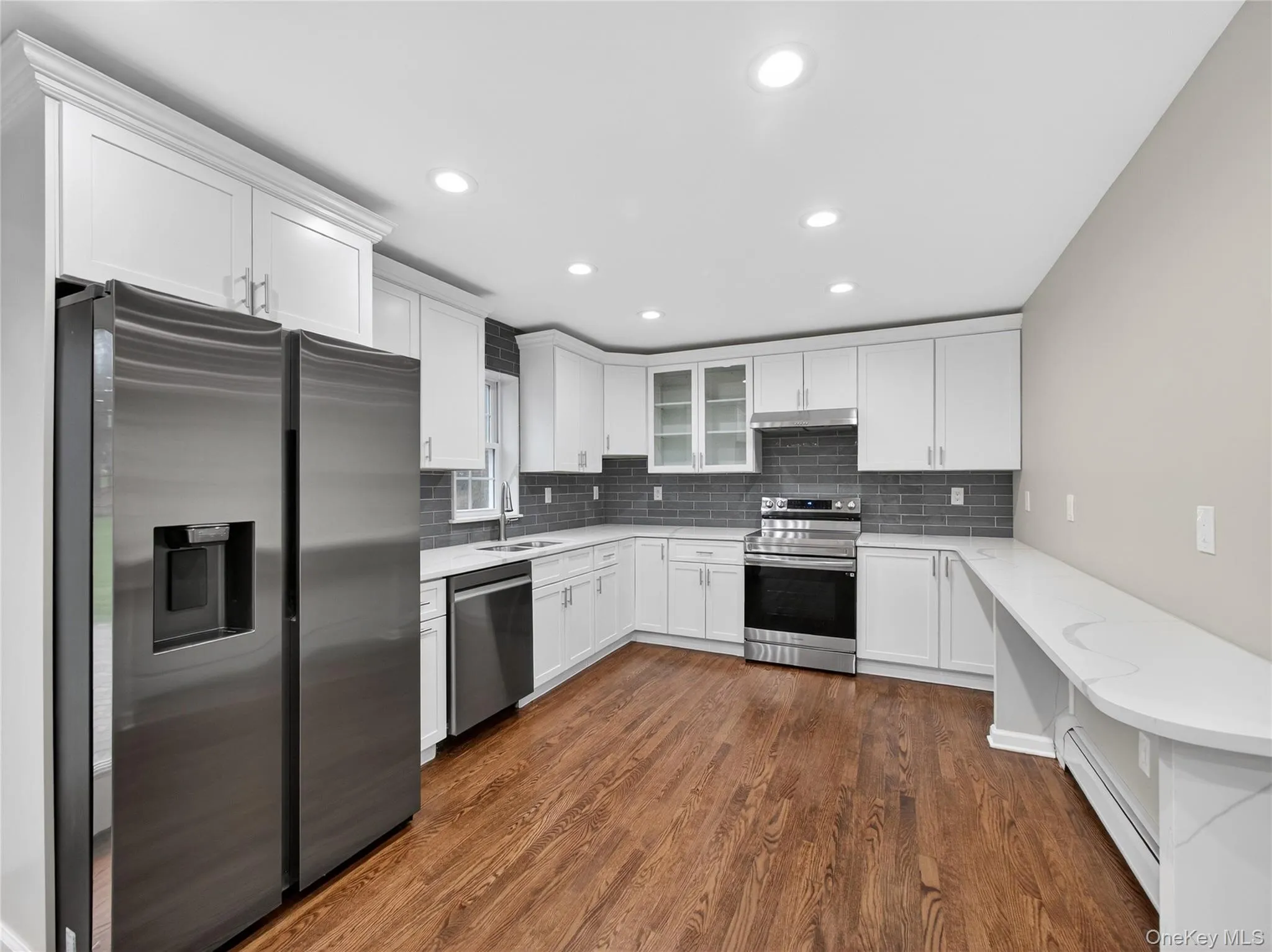 Kitchen featuring stainless steel appliances, white cabinets, and recessed lighting Kitchen featuring stainless steel appliances, white cabinets, and recessed lighting