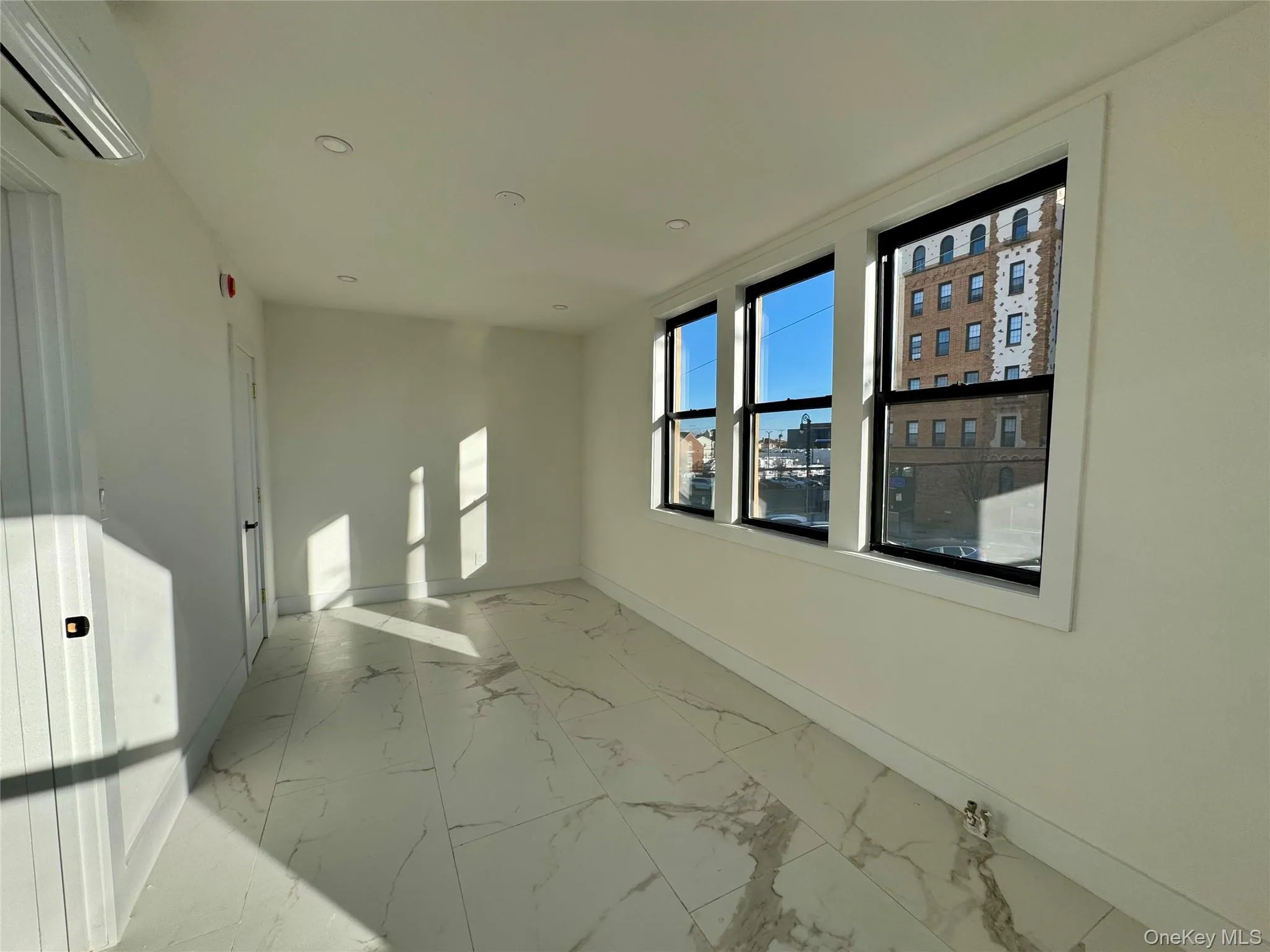 Unfurnished room with a wall mounted air conditioner Unfurnished room with a wall mounted air conditioner