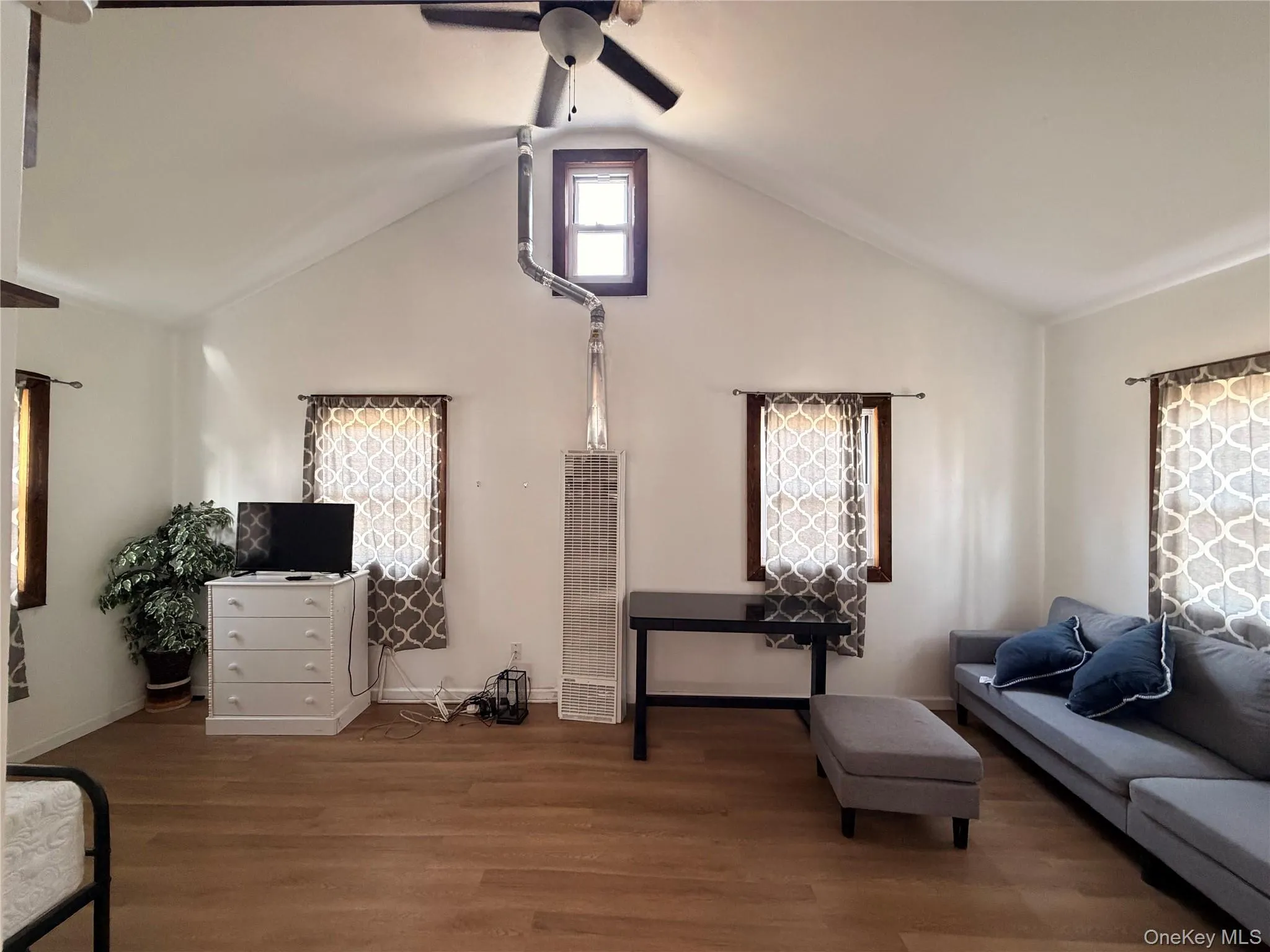 Bright and spacious living area with high ceilings and natural light Bright and spacious living area with high ceilings and natural light