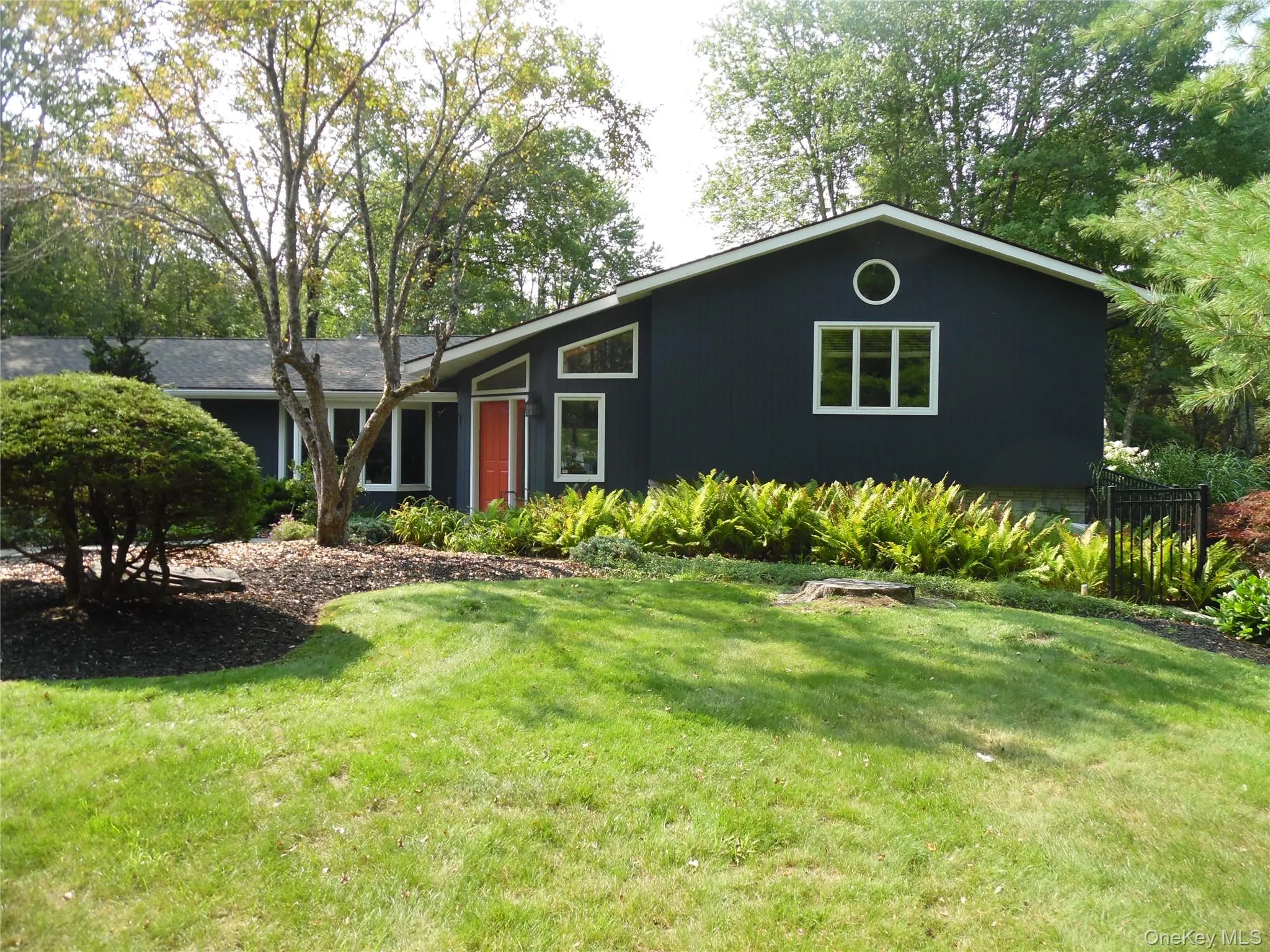 Dark-hued exterior siding with white window frames Dark-hued exterior siding with white window frames