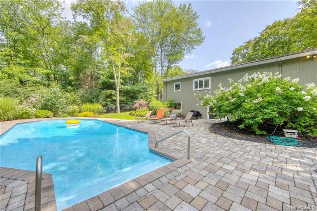 Swimming pool featuring a patio area Swimming pool featuring a patio area