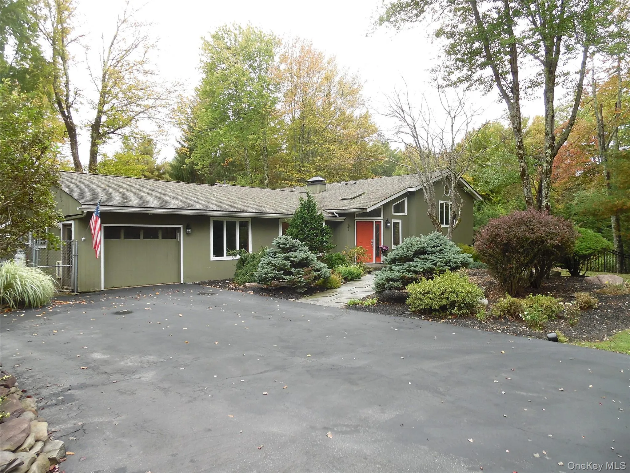 View of front of home with an attached garage and asphalt driveway View of front of home with an attached garage and asphalt driveway