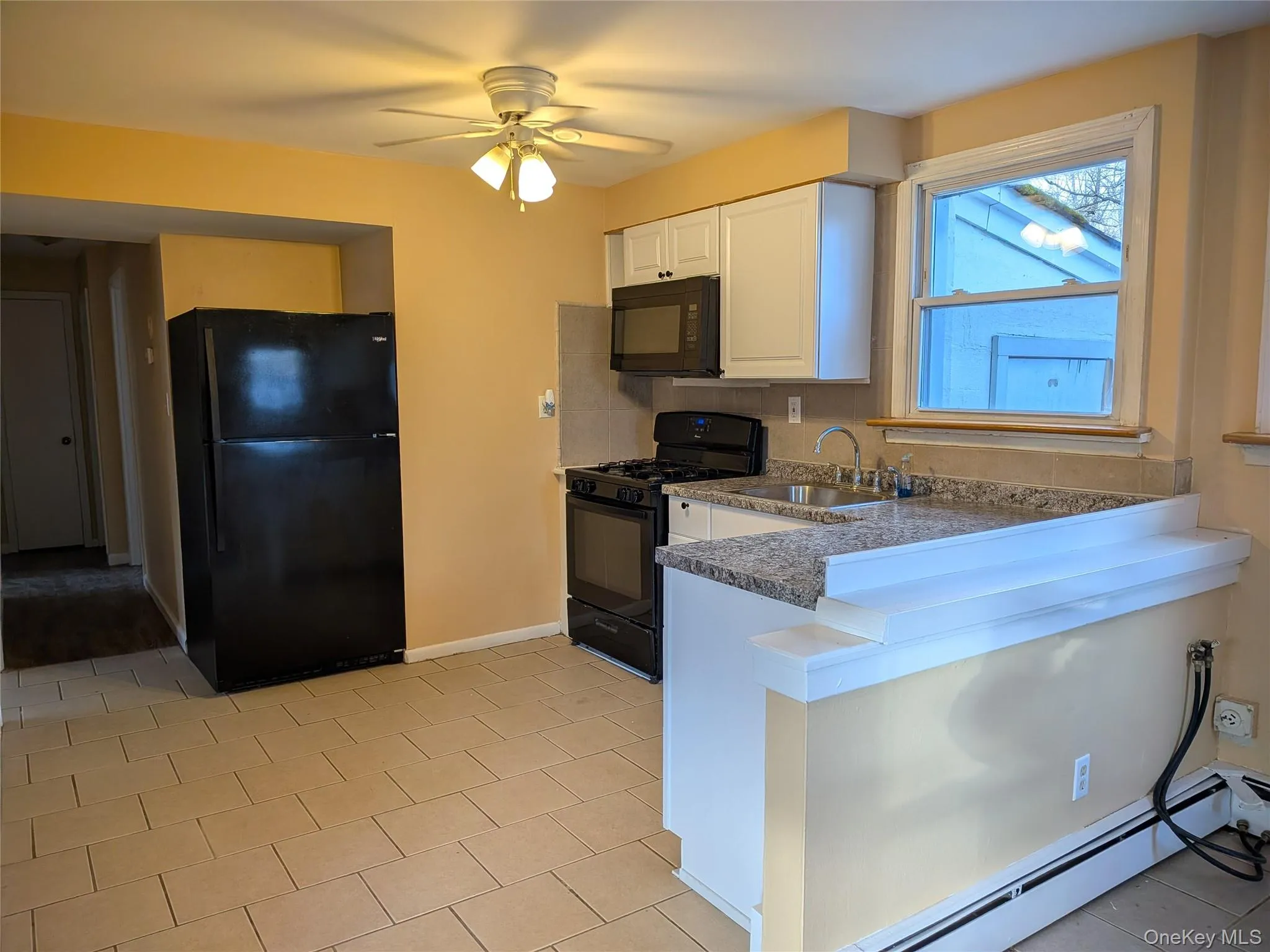 Updated kitchenn with new cabinets, counter and sink Updated kitchenn with new cabinets, counter and sink
