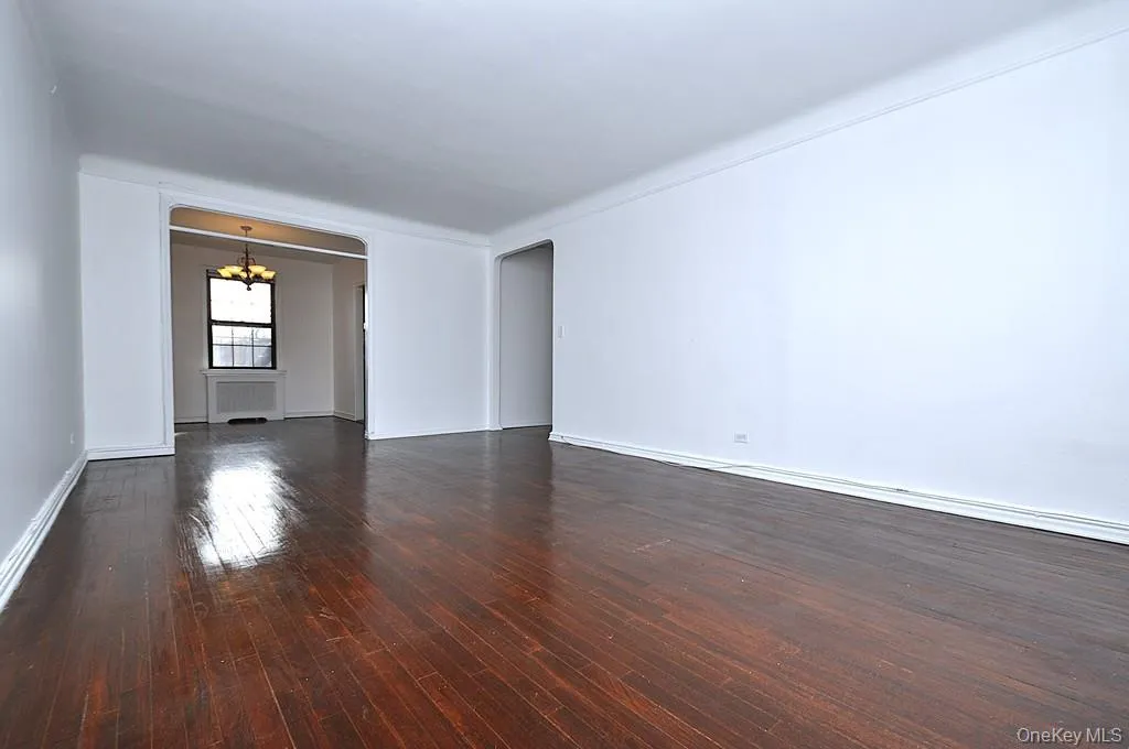 The large living room has hardwood floors, overlooks the manicured courtyard and opens to the dining room. The living room is approx. 19'-9" x 12'7". The large living room has hardwood floors, overlooks the manicured courtyard and opens to the dining room. The living room is approx. 19'-9" x 12'7".