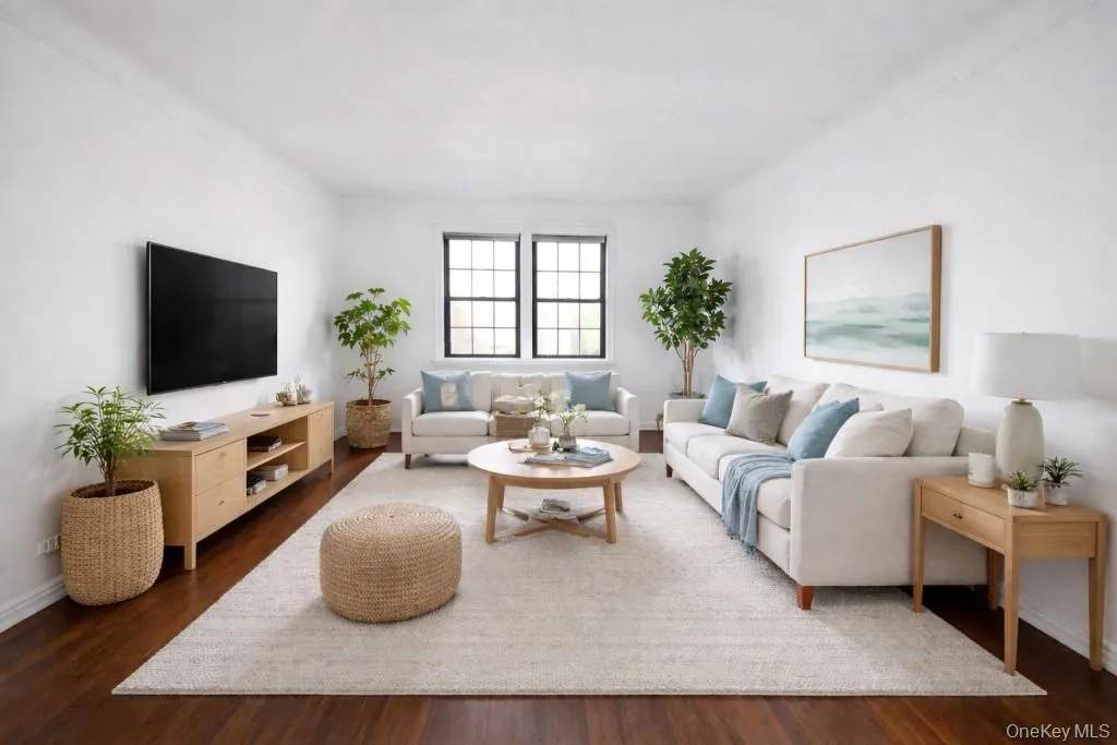 Photo visually staged, The large living room has hardwood floors, overlooks the manicured courtyard and opens to the dining room. The living room is approx. 19'-9" x 12'7". Photo visually staged, The large living room has hardwood floors, overlooks the manicured courtyard and opens to the dining room. The living room is approx. 19'-9" x 12'7".