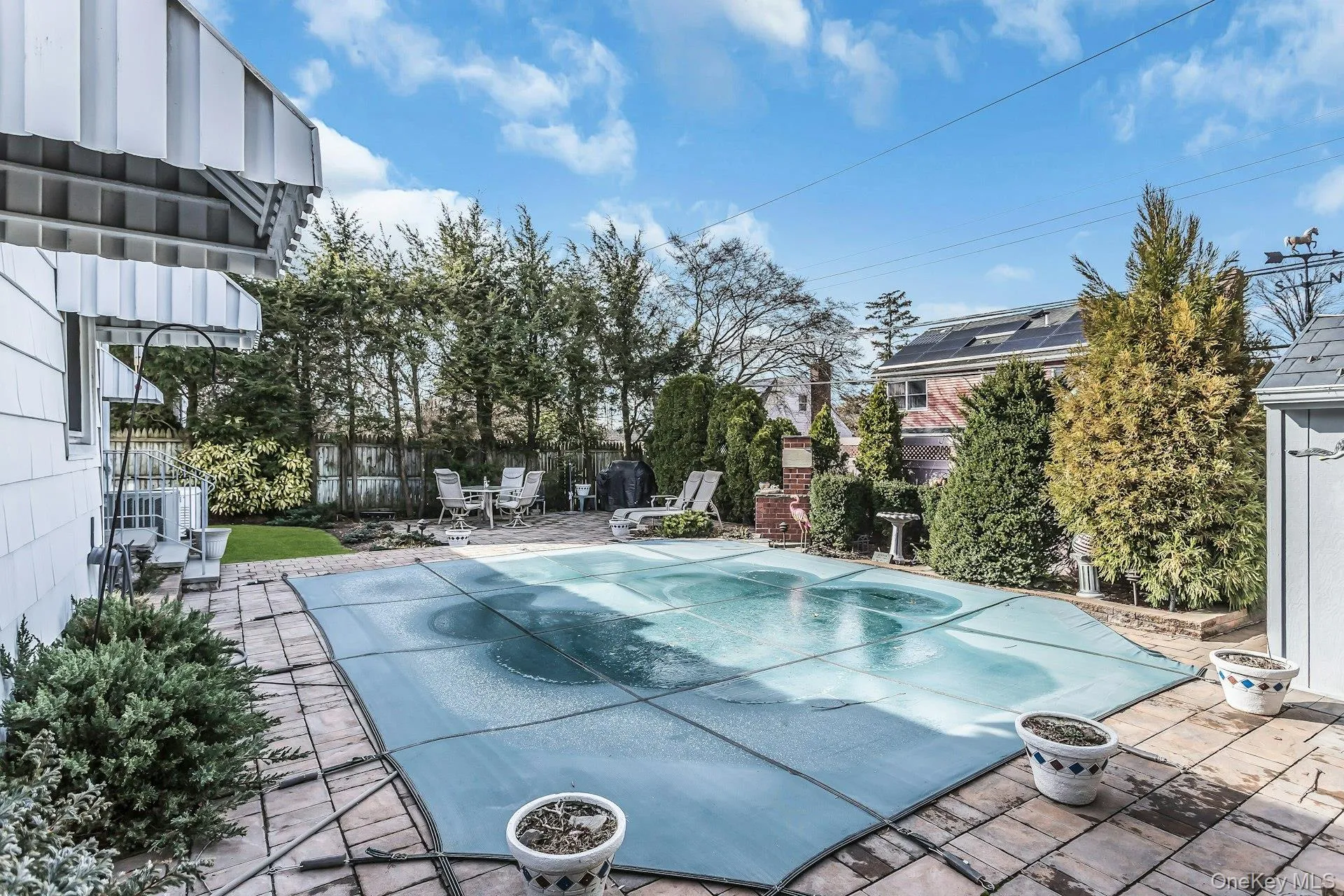 View of pool with patio surround and a covered pool View of pool with patio surround and a covered pool