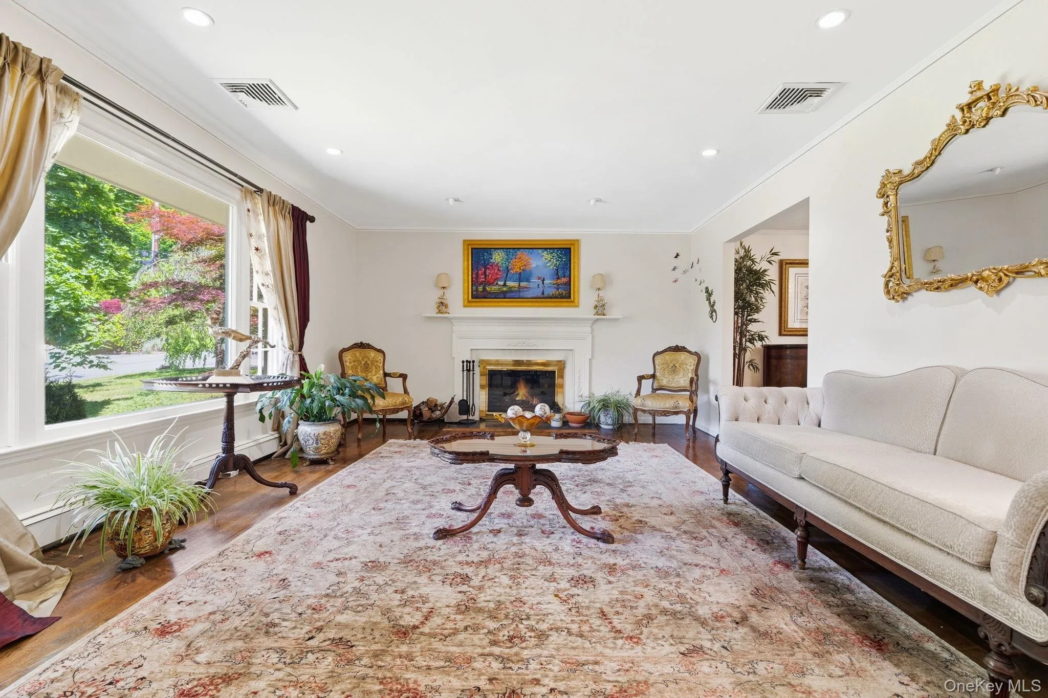 Gather around the fireplace while natural light pours through the picture window. Gather around the fireplace while natural light pours through the picture window.