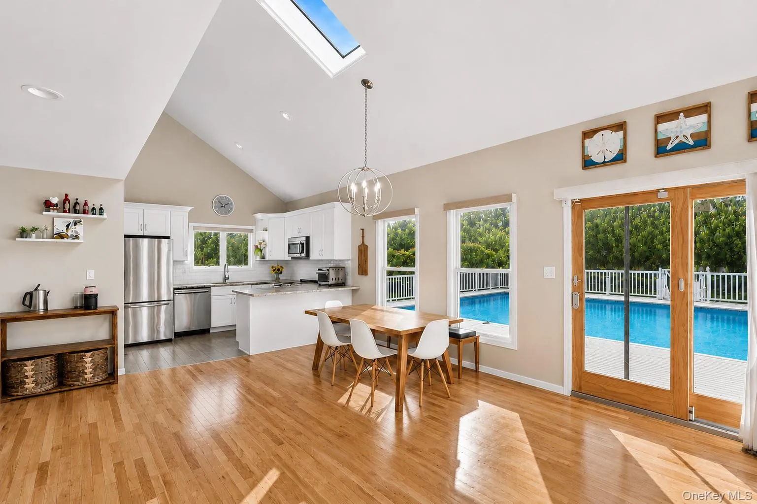 Post-modern home featuring an open living room with fireplace, glass sliders to the inground pool, and an open eat-in kitchen. Post-modern home featuring an open living room with fireplace, glass sliders to the inground pool, and an open eat-in kitchen.