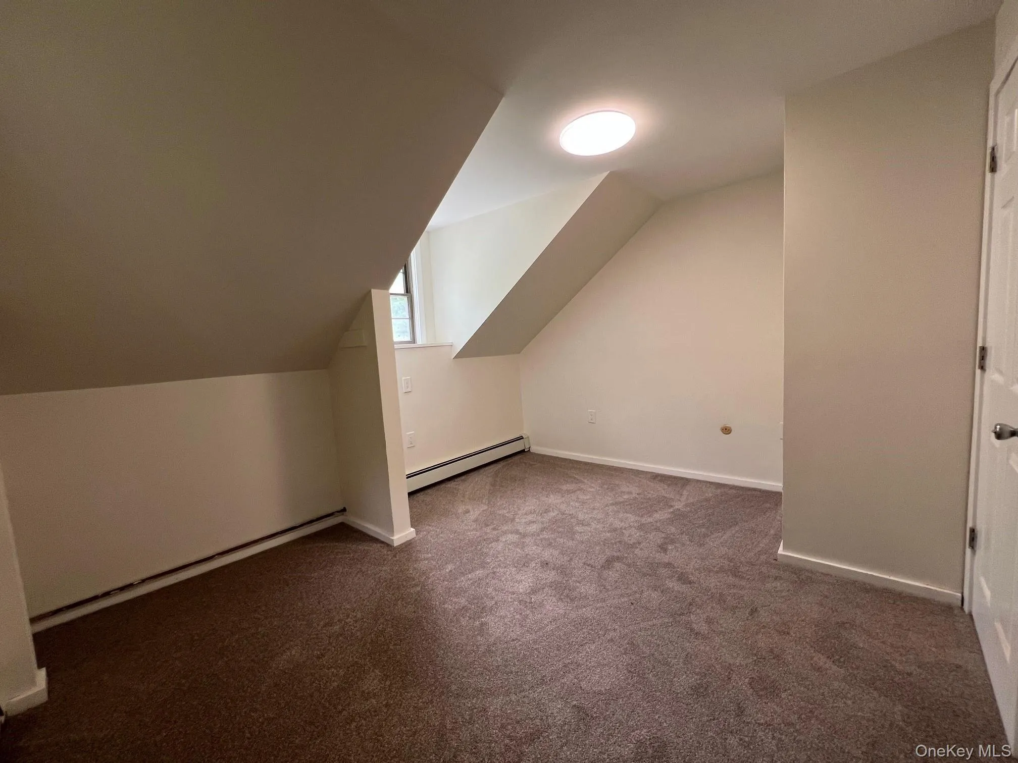 Bonus room with carpet floors, a baseboard radiator, and lofted ceiling Bonus room with carpet floors, a baseboard radiator, and lofted ceiling