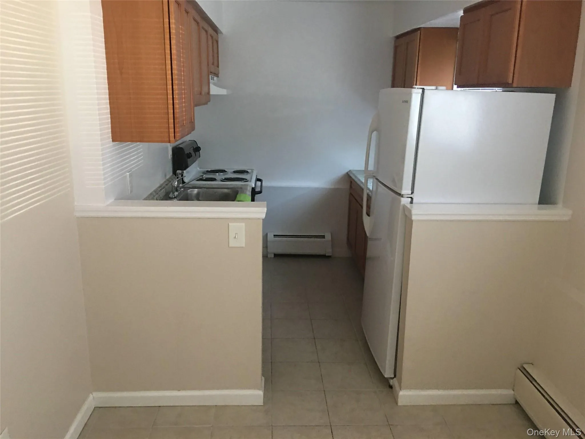 Galley kitchen separated from dining room by half wall. Galley kitchen separated from dining room by half wall.