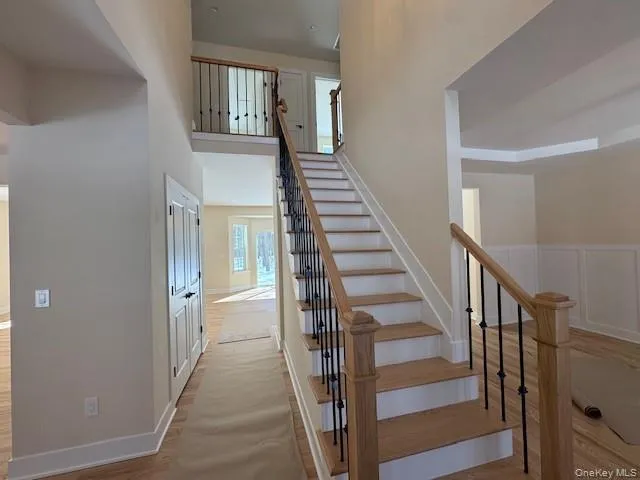 Stairway with a high ceiling and wood finished floors Stairway with a high ceiling and wood finished floors