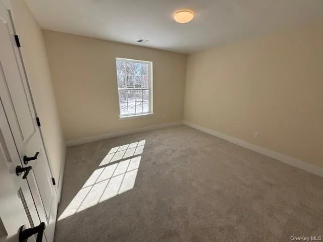 Unfurnished bedroom with light colored carpet Unfurnished bedroom with light colored carpet