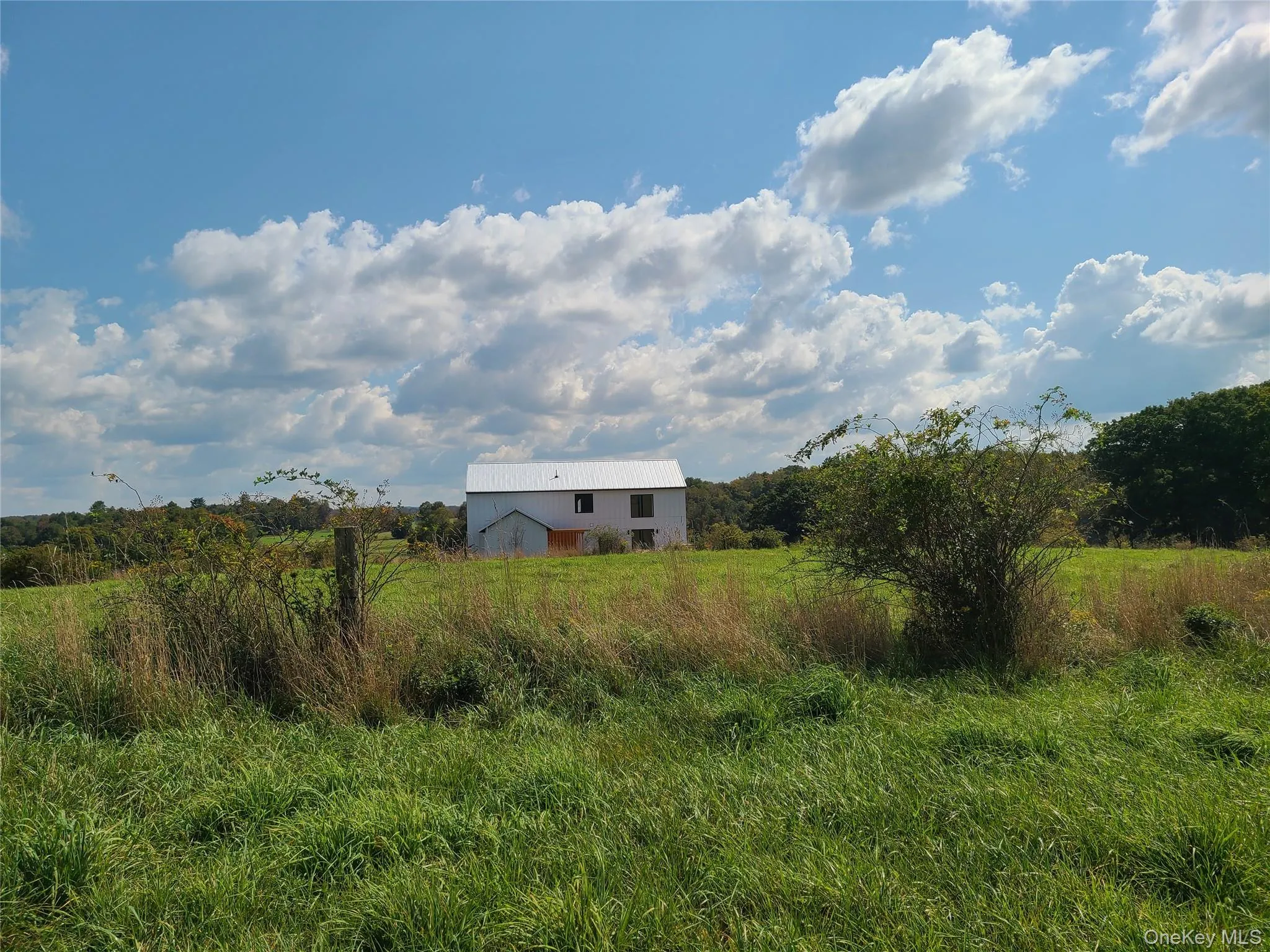 View of yard featuring an outbuilding and a rural view View of yard featuring an outbuilding and a rural view