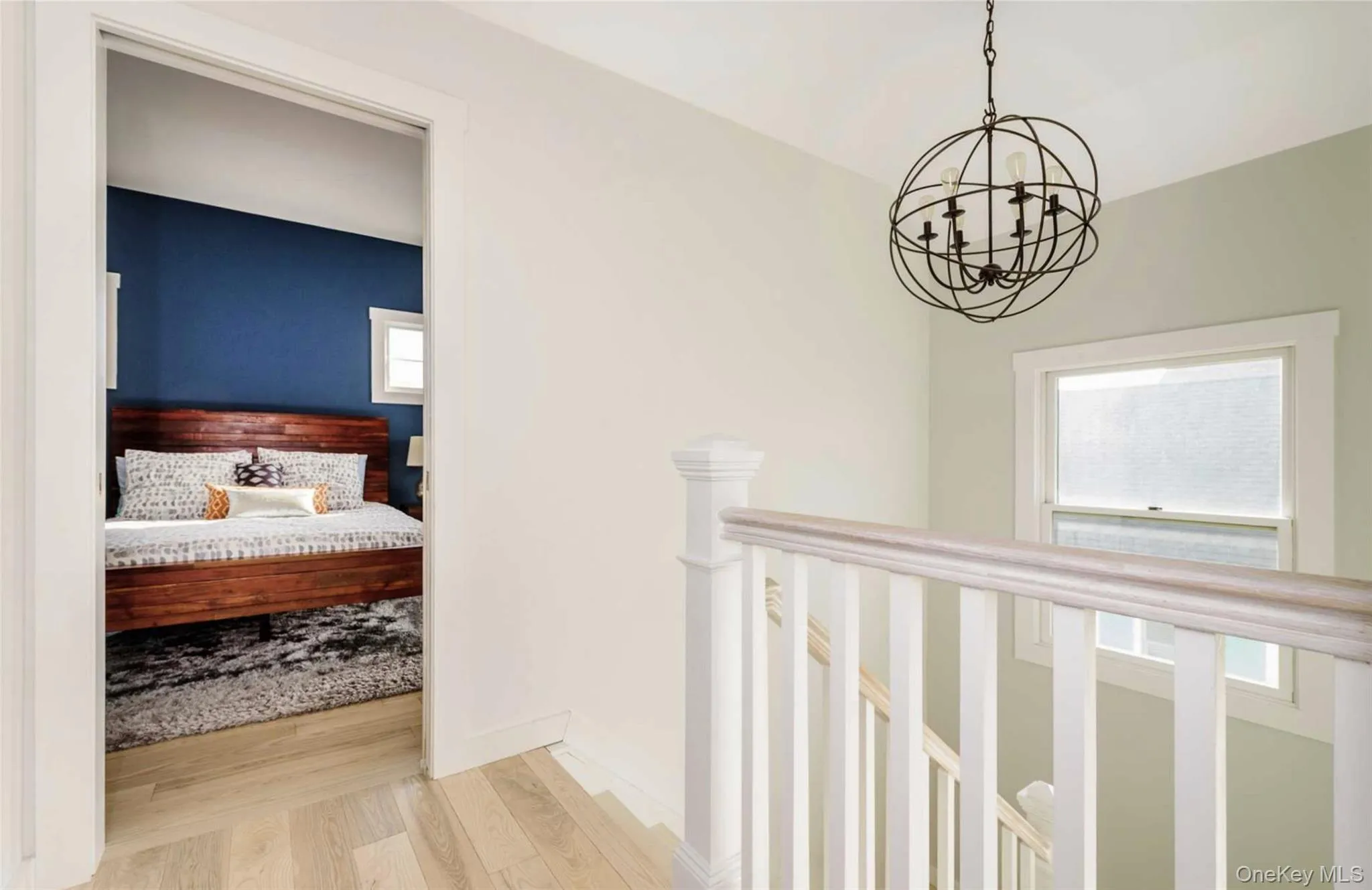 Corridor featuring a chandelier, hardwood / wood-style floors, and a healthy amount of sunlight Corridor featuring a chandelier, hardwood / wood-style floors, and a healthy amount of sunlight