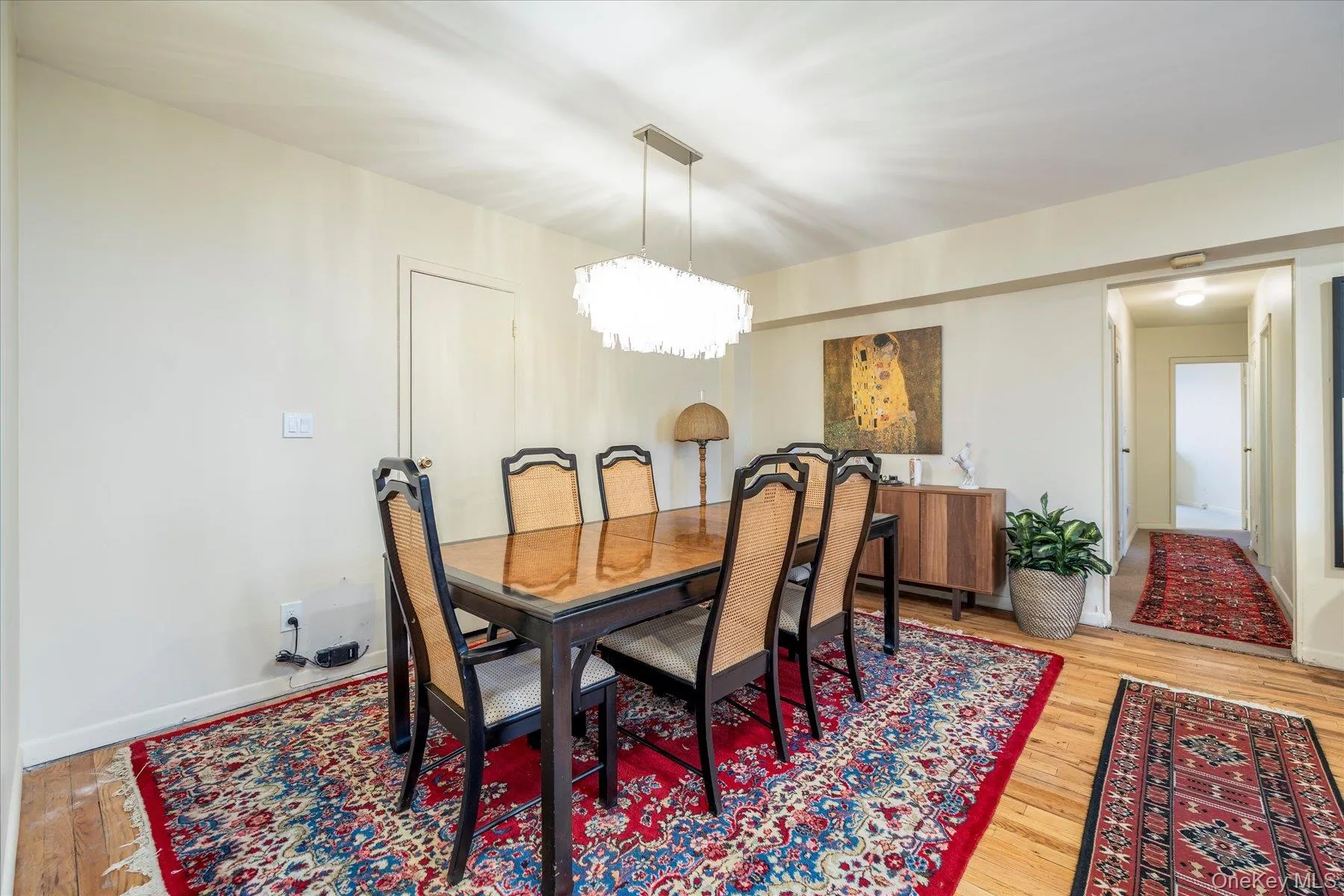 Dining area with light floors and suspended lighting Dining area with light floors and suspended lighting