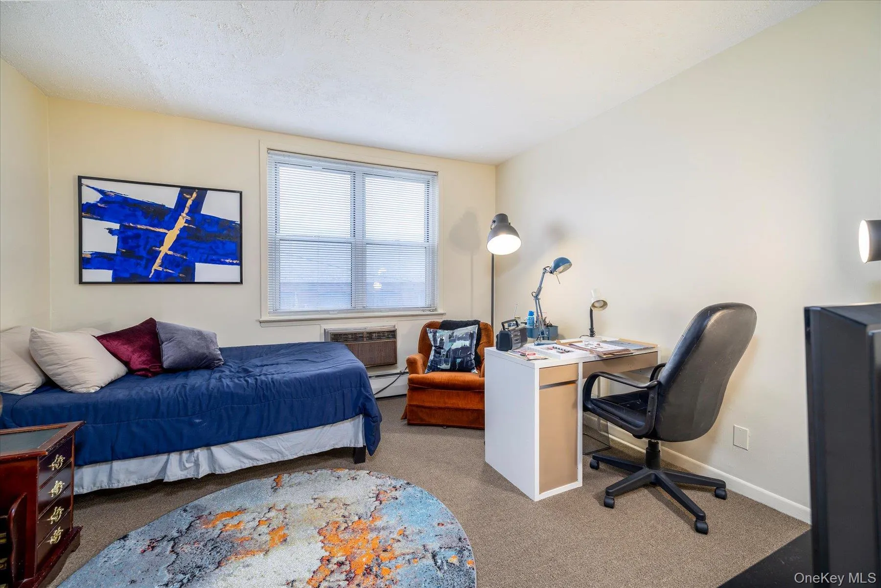 Bedroom featuring carpet and a baseboard radiator Bedroom featuring carpet and a baseboard radiator