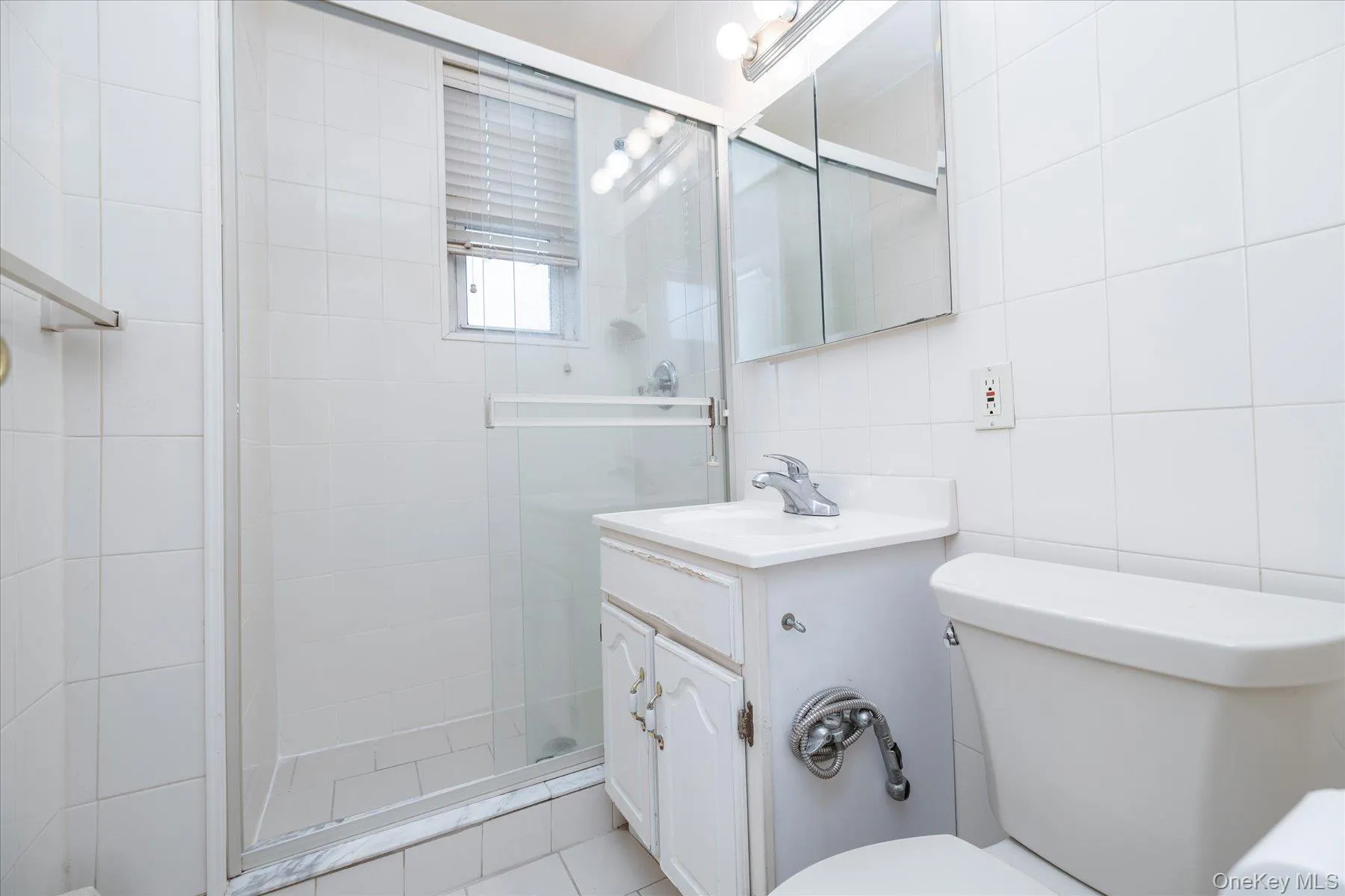 Full Bathroom with vanity, a stall shower and tile walls Full Bathroom with vanity, a stall shower and tile walls