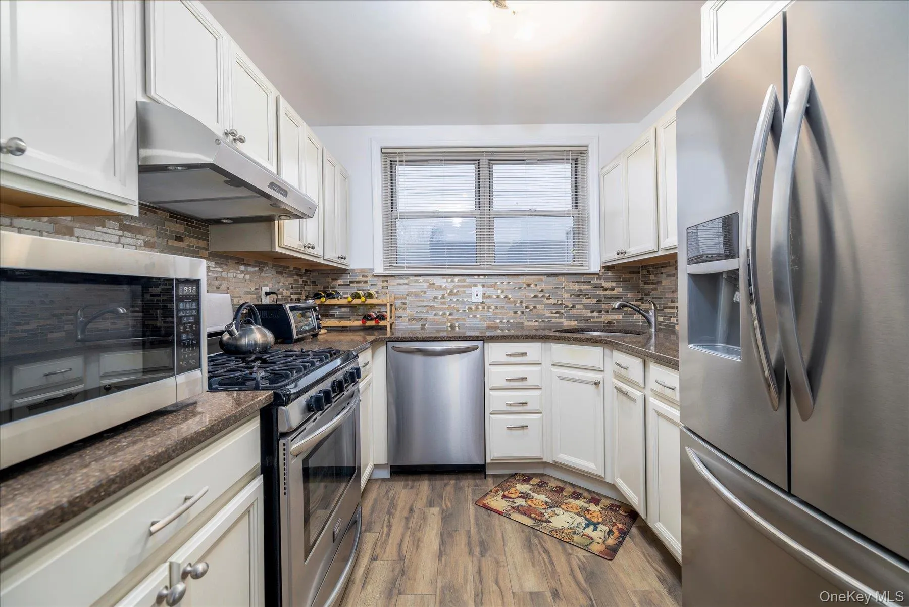 Kitchen with stainless steel appliances and white cabinets Kitchen with stainless steel appliances and white cabinets