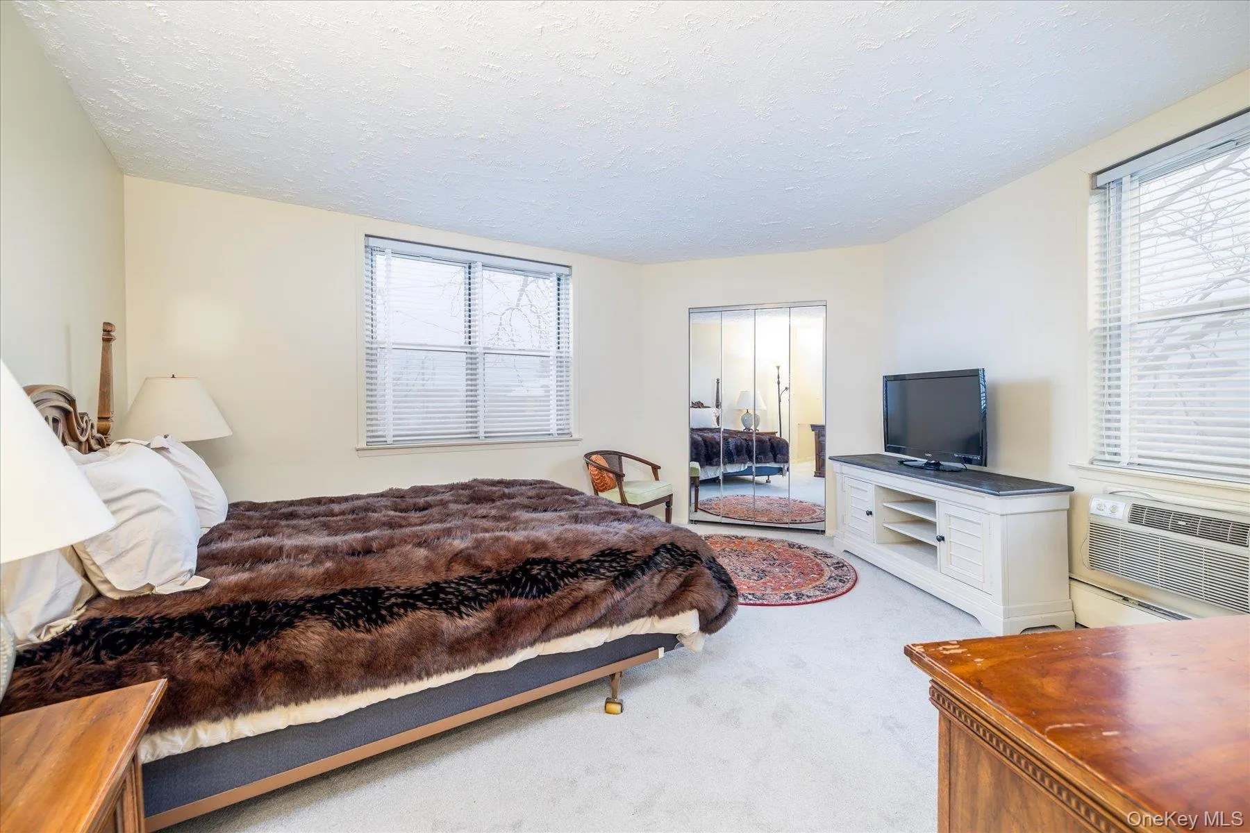 Bedroom with light carpet and a baseboard heating unit Bedroom with light carpet and a baseboard heating unit