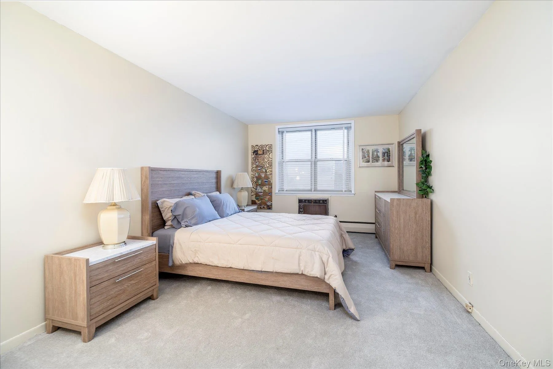 Carpeted bedroom featuring baseboards and a baseboard radiator Carpeted bedroom featuring baseboards and a baseboard radiator
