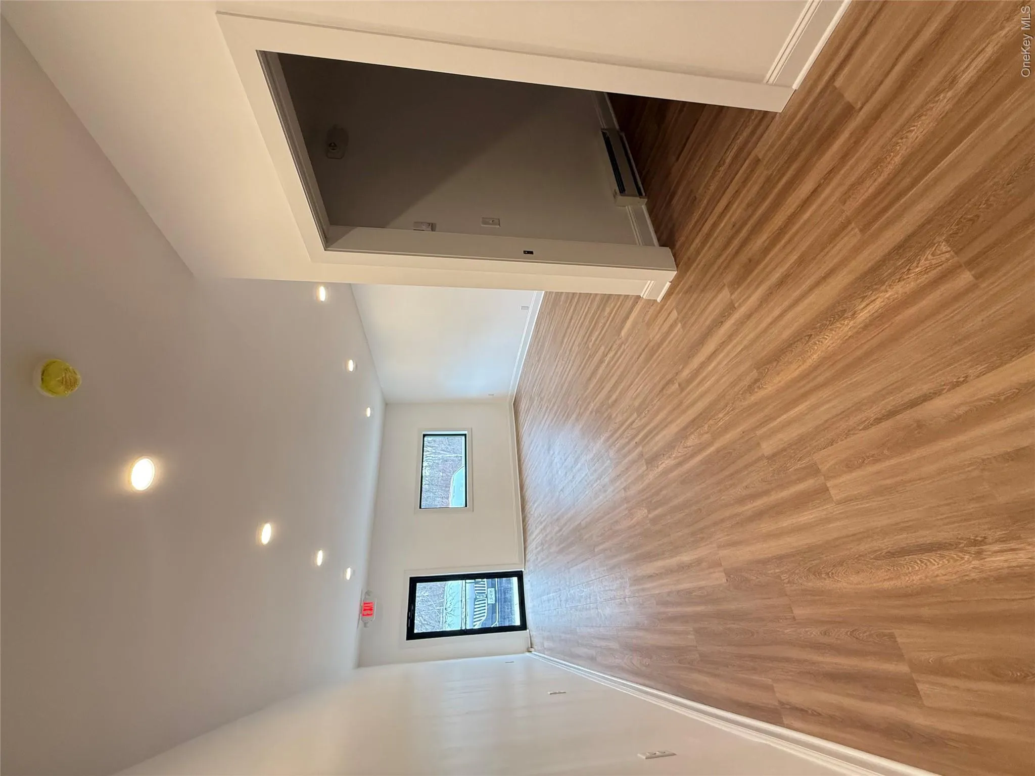Spare room featuring light wood-style flooring, a baseboard radiator, and recessed lighting Spare room featuring light wood-style flooring, a baseboard radiator, and recessed lighting