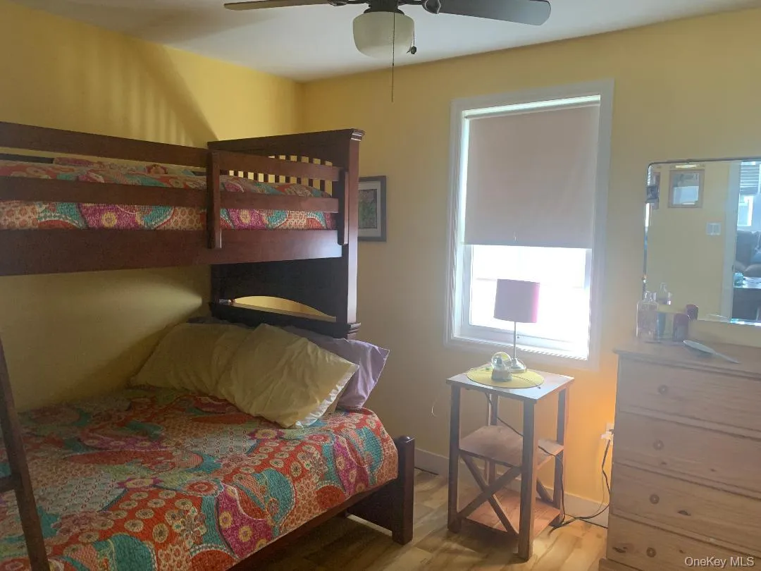 Bedroom featuring wood finished floors and ceiling fan Bedroom featuring wood finished floors and ceiling fan