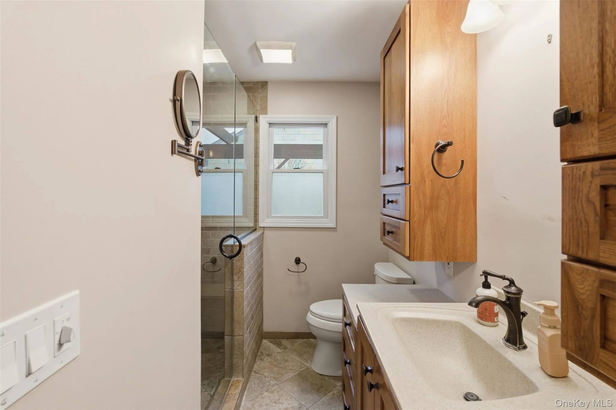 Bathroom featuring vanity and a stall shower Bathroom featuring vanity and a stall shower