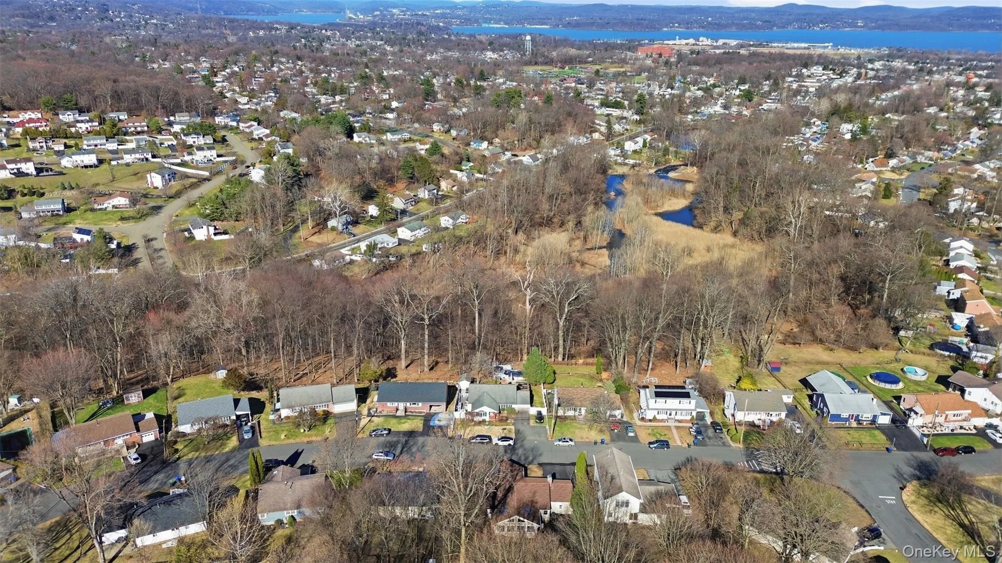 Aerial perspective of suburban area featuring a water and mountain view Aerial perspective of suburban area featuring a water and mountain view