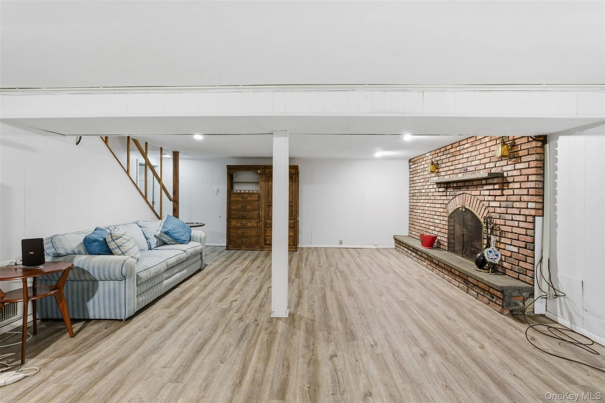 Living area with light wood-style floors and a fireplace Living area with light wood-style floors and a fireplace