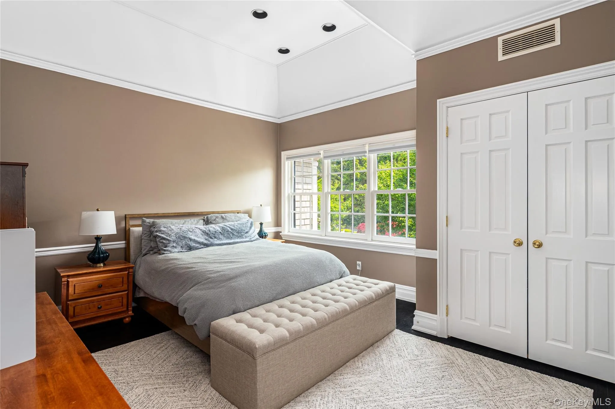 Bedroom featuring baseboards, a closet, and ornamental molding Bedroom featuring baseboards, a closet, and ornamental molding