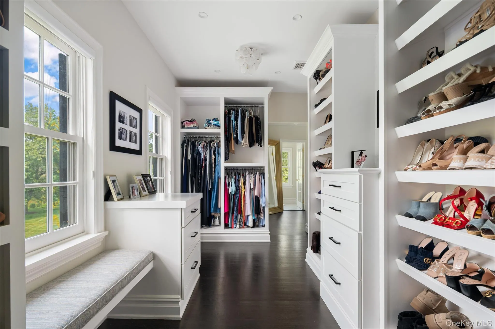 Walk in closet with dark wood-style floors Walk in closet with dark wood-style floors