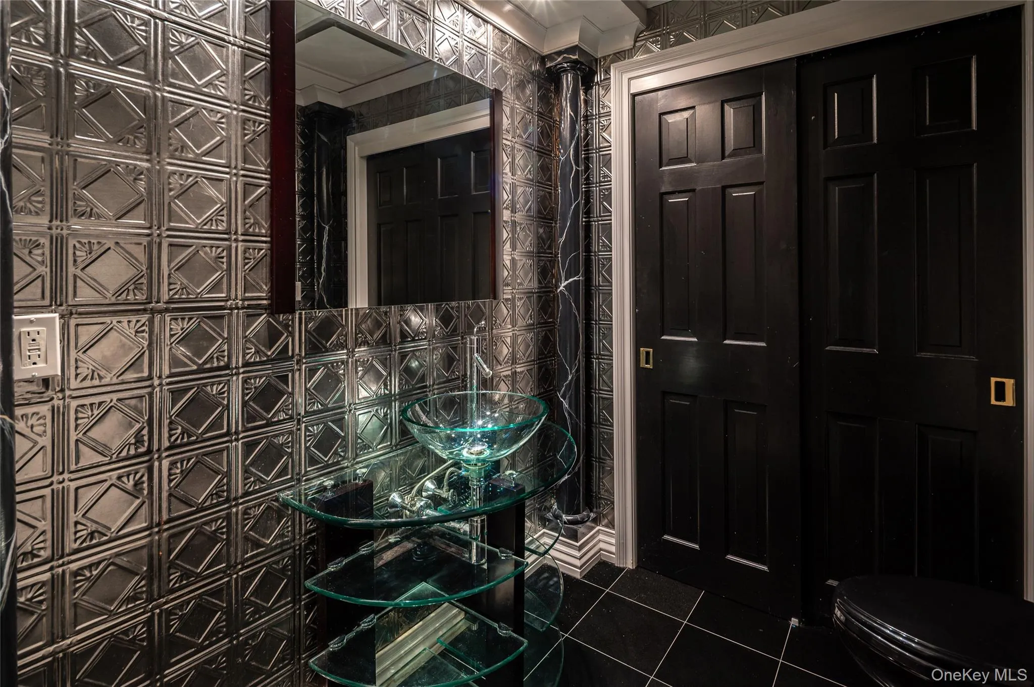Bathroom with tile patterned floors, toilet, and tile walls Bathroom with tile patterned floors, toilet, and tile walls