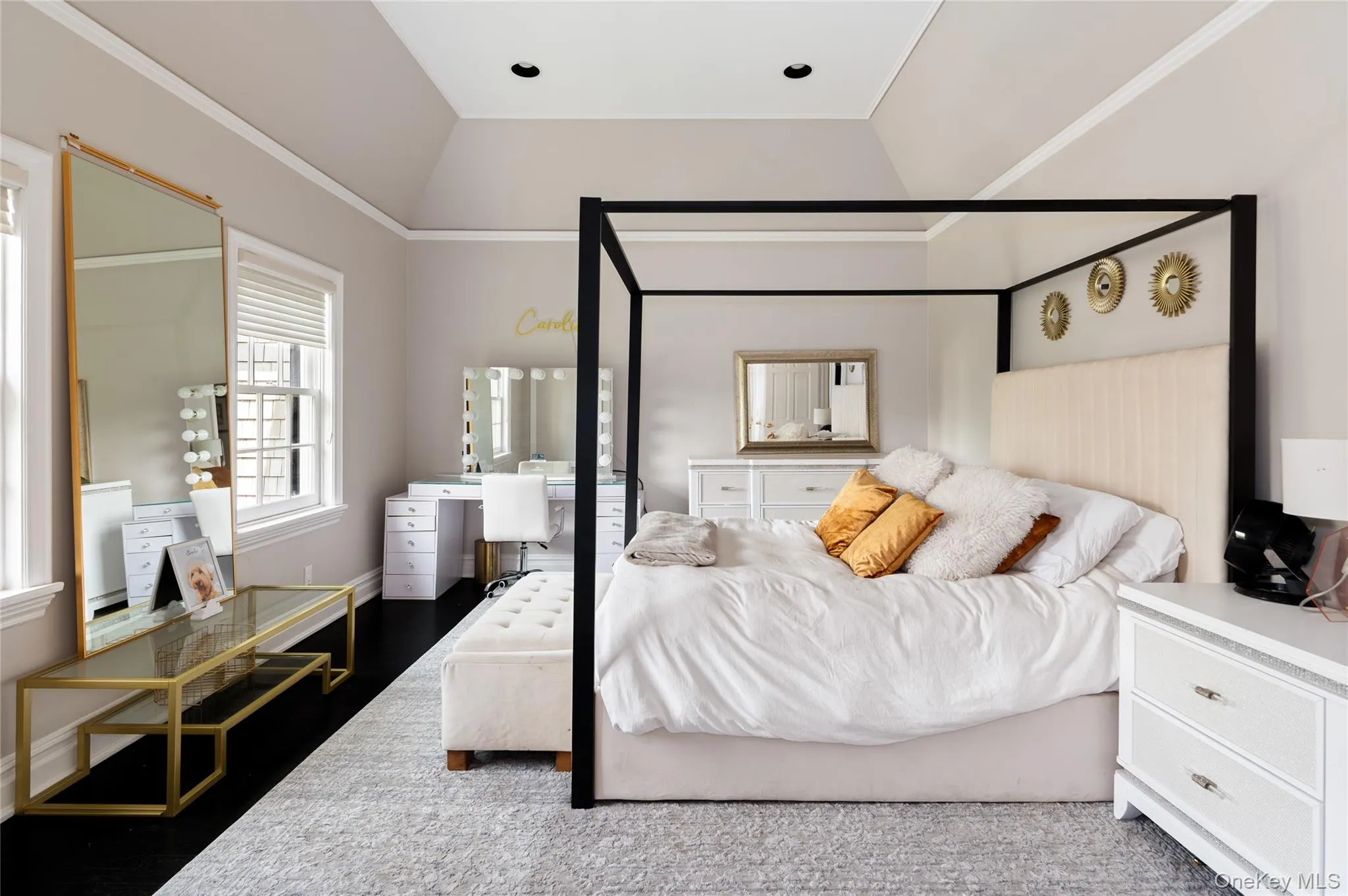 Bedroom featuring lofted ceiling, an office area, and wood finished floors Bedroom featuring lofted ceiling, an office area, and wood finished floors