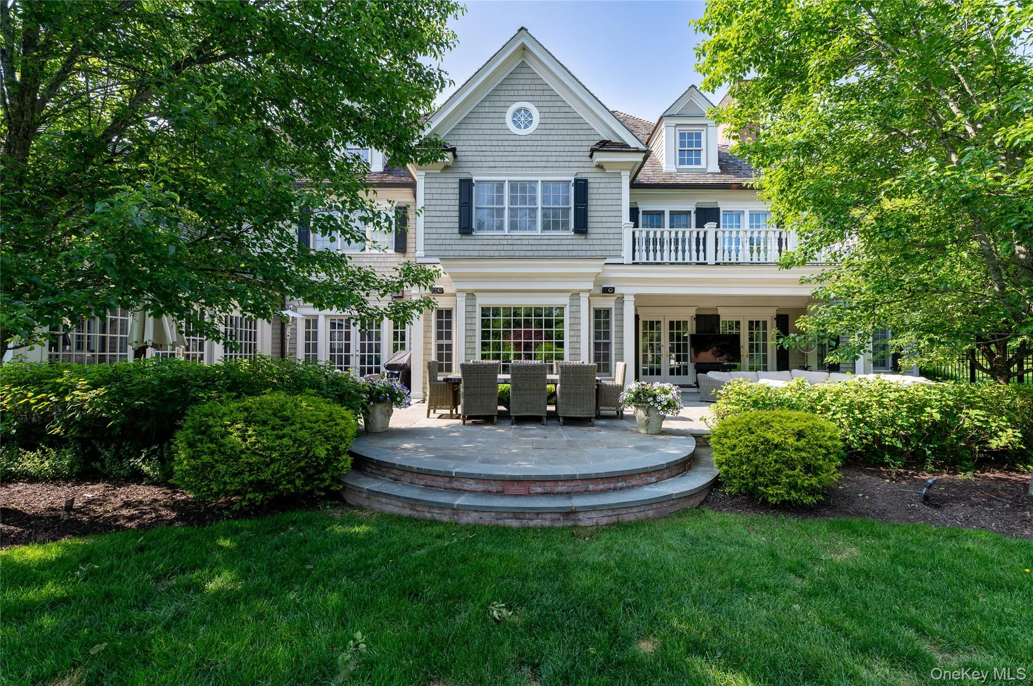 Rear view of house featuring french doors, a lawn, and a patio area Rear view of house featuring french doors, a lawn, and a patio area