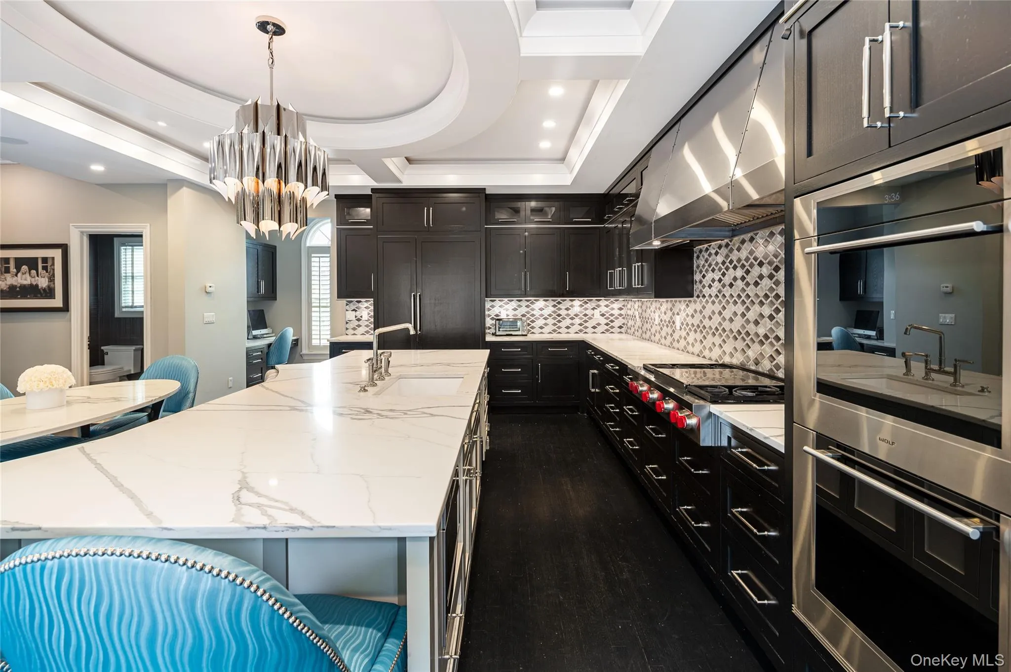 Kitchen with a sink, stainless steel appliances, tasteful backsplash, a center island with sink, and ornamental molding Kitchen with a sink, stainless steel appliances, tasteful backsplash, a center island with sink, and ornamental molding