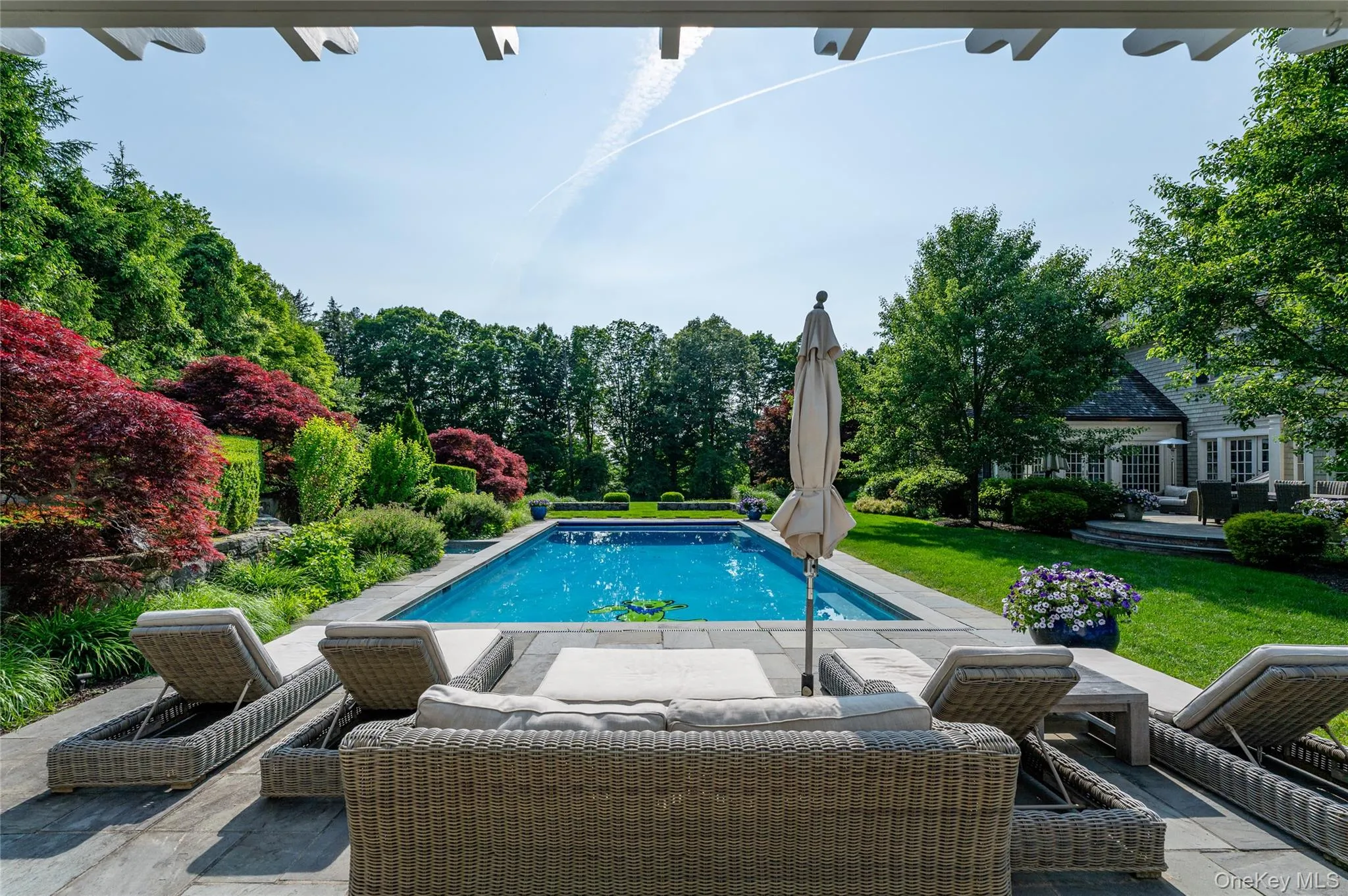 Outdoor pool featuring a patio area and a lawn Outdoor pool featuring a patio area and a lawn