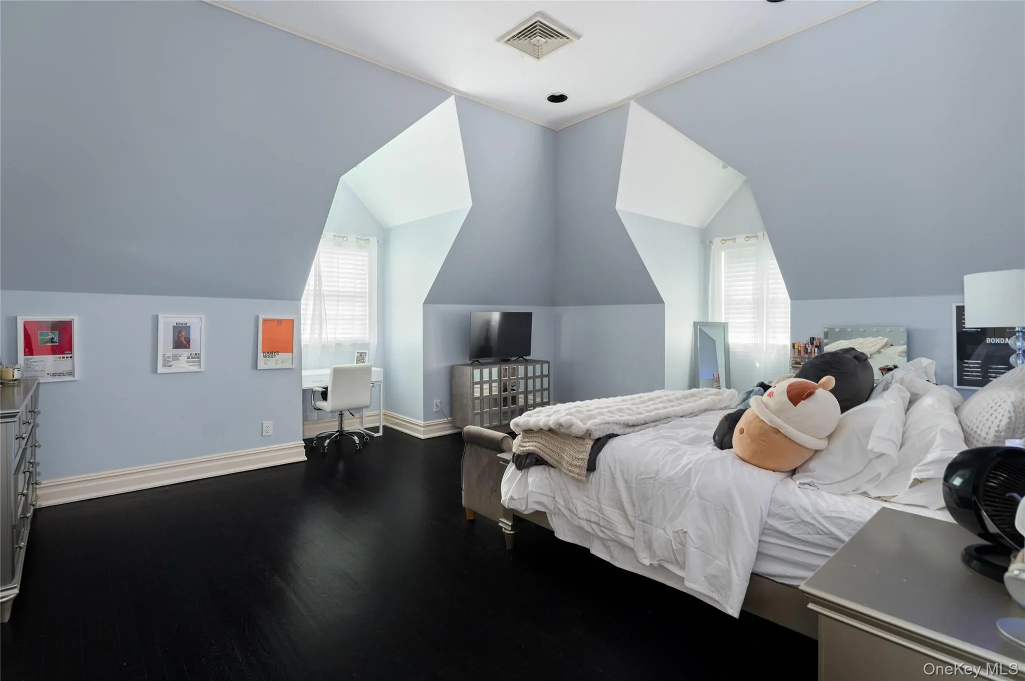 Bedroom featuring wood finished floors, baseboards, and lofted ceiling Bedroom featuring wood finished floors, baseboards, and lofted ceiling
